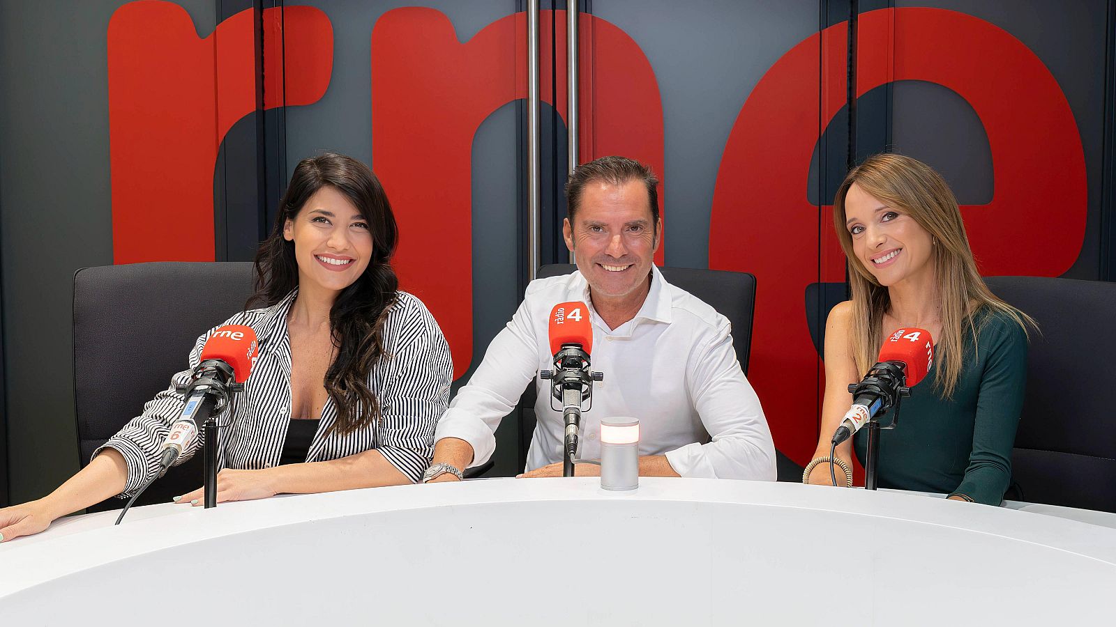 Ares Teixidó, Vador Lladó i Montse Vidal posen somrients davant dels micròfons de Ràdio 4 en un estudi. Es veuen els logos de RNE i el número 4 als micròfons.