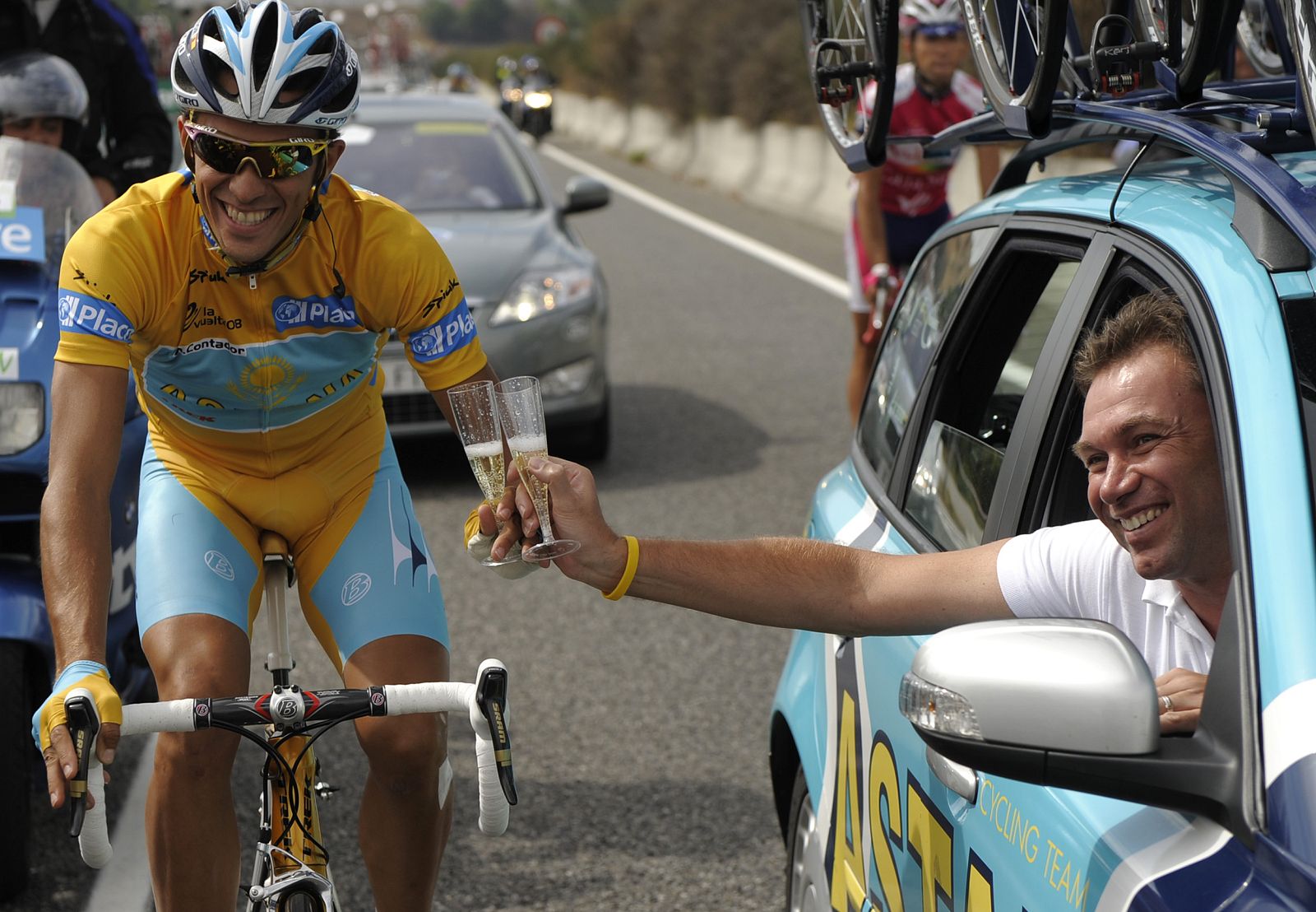 Astana rider Contador celebrates after winning the Tour of Spain "La Vuelta" cycling race with Astana team manager Bruyneel during the last stage between San Sebastian de los Reyes and Madrid