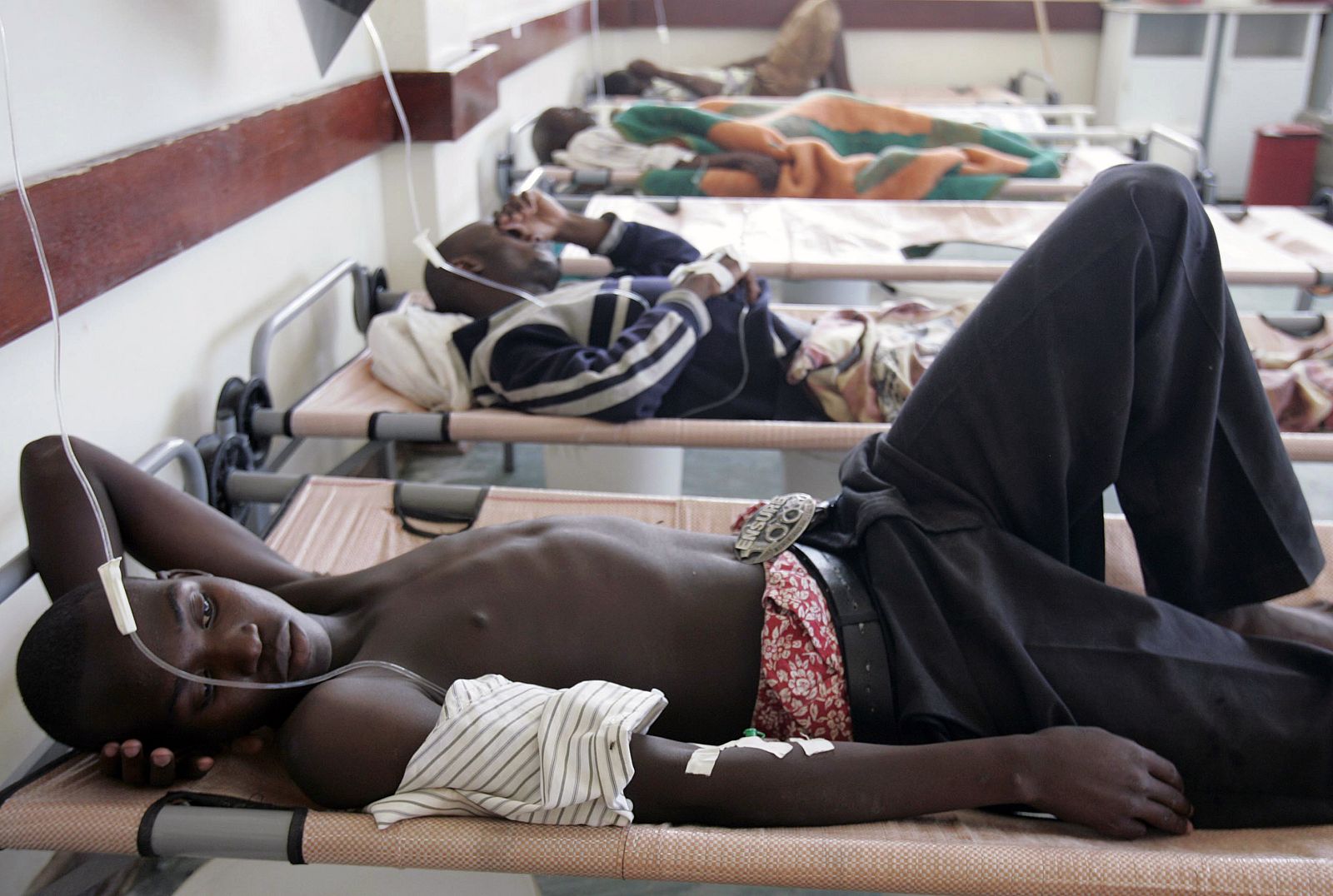 Cholera patients rest on their beds inside the male ward of Budiriro Polyclinic in Harare