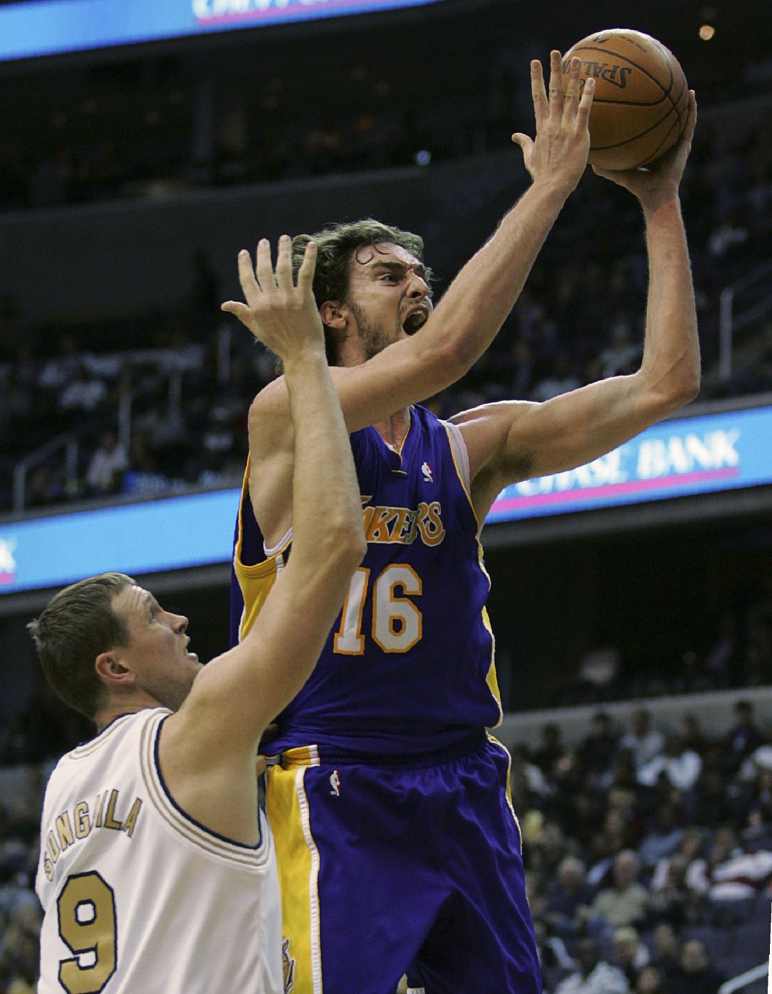 Los Angeles Lakers' Gasol goes to the hoop past Washington Wizards' Songaila during their NBA game in Washington