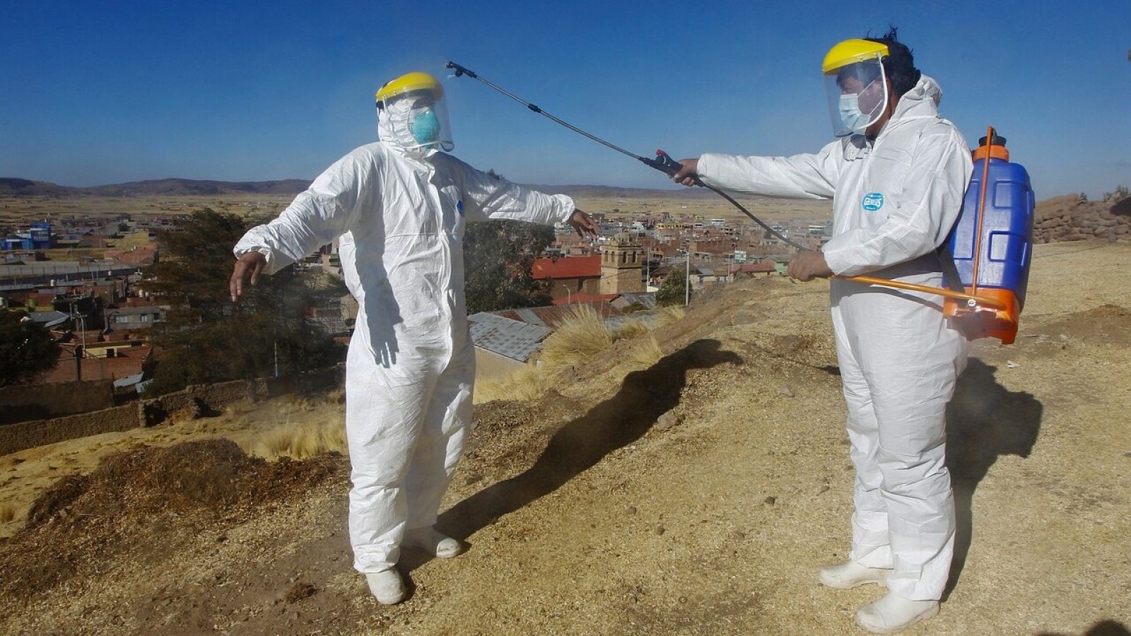 Empleados de la funeraria se preparan para el entierro de un fallecido con coronavirus en Acora, Perú.