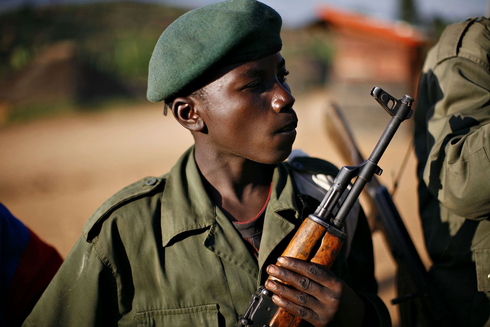 A child soldier stands at the front line in eastern Congo