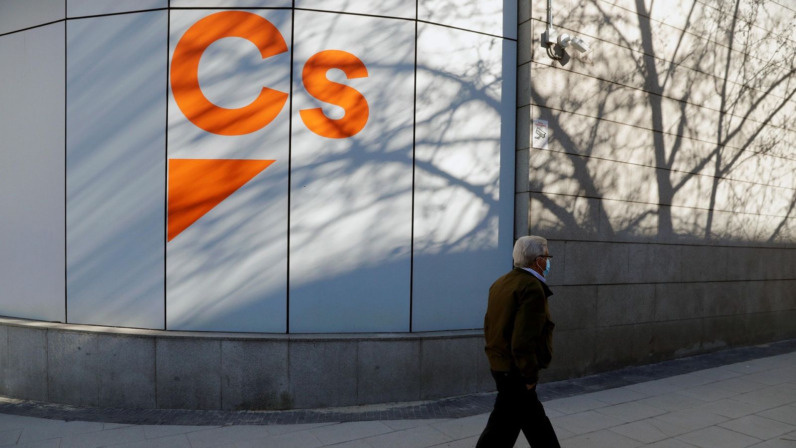 Un hombre pasea junto a la sede de Ciudadanos en Madrid