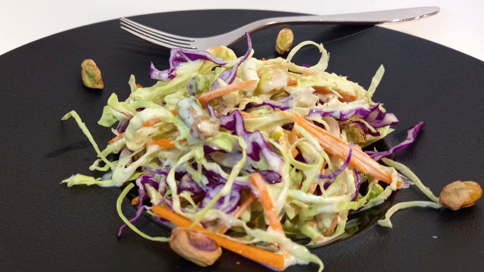 Ensalada de coles con salsa de yogur y pistachos