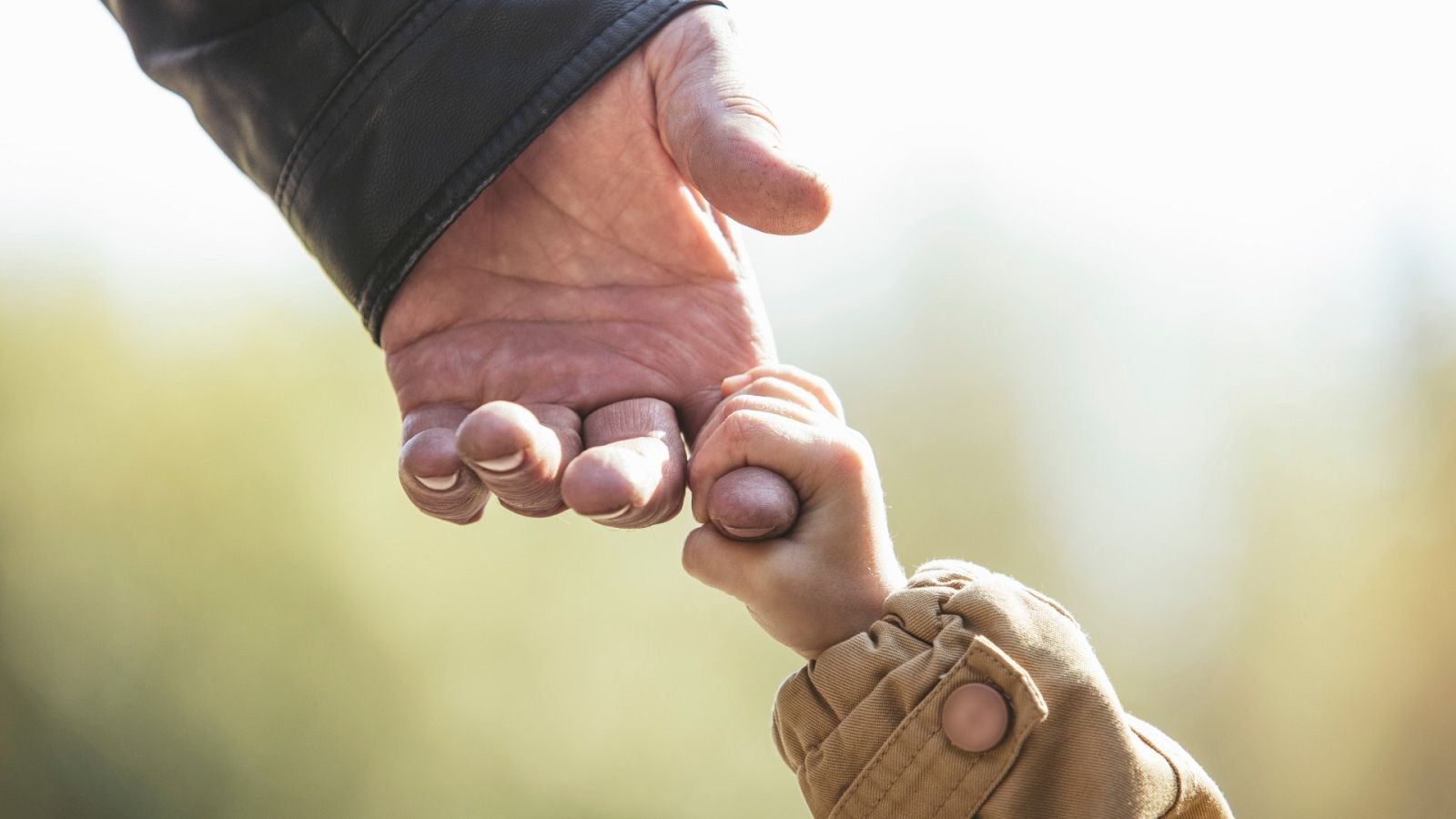 Un abuelo y su nieto se dan la mano