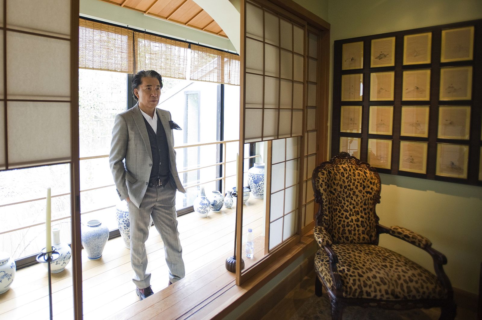 Japanese designer Kenzo Takada, known as Kenzo, poses for the media in his loft after a news conference in Paris