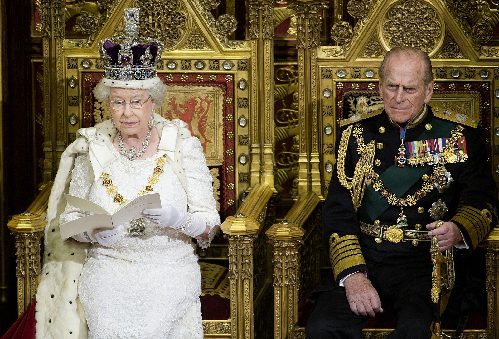 Britain's Queen Elizabeth wears the Imperial State Crown as she reads the Queen's Speech from the throne seated next to Prince Philip during the State Opening of Parliament in London,