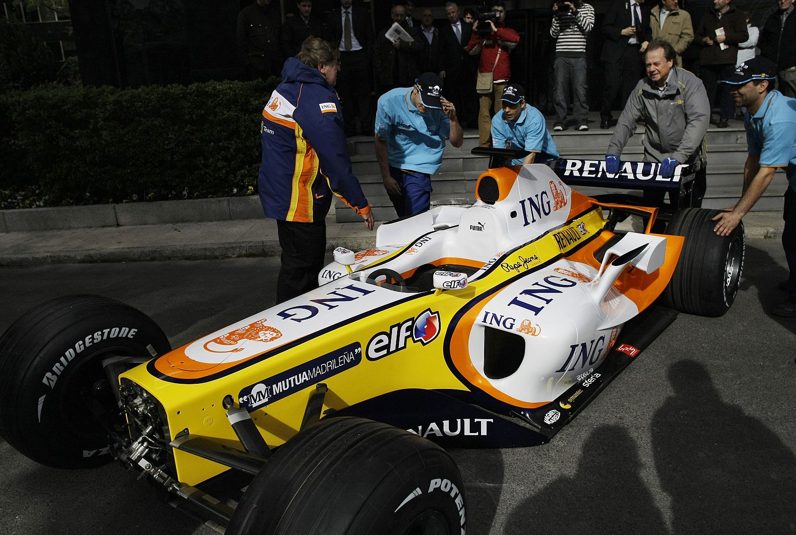Workers prepare a Renault F1 R28 car which will be displayed in Mutua Madrilena in Madrid