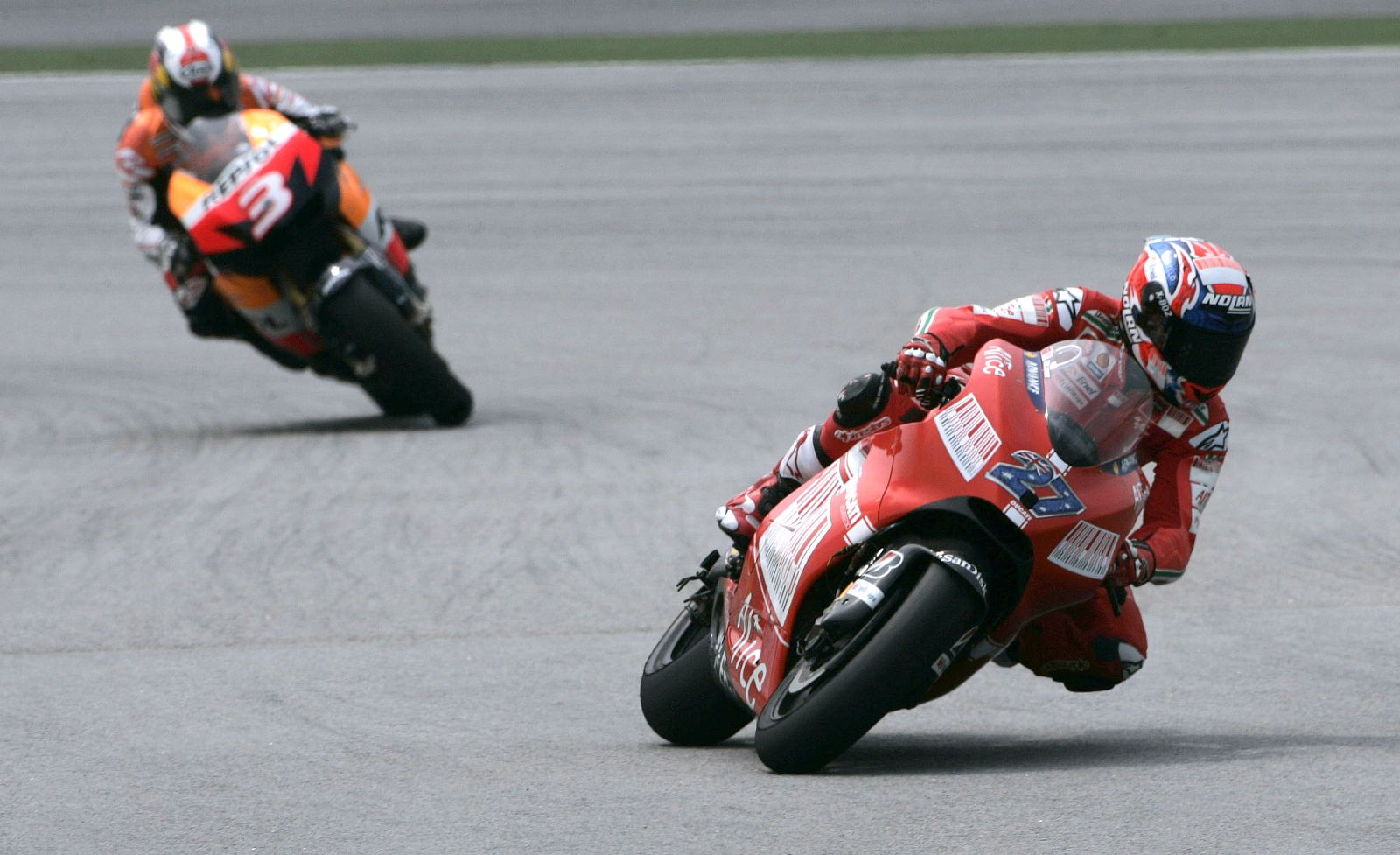 Ducati MotoGP rider, Stoner of Australia leads Honda's Pedrosa of Spain during a pre-season testing at Sepang International Circuit