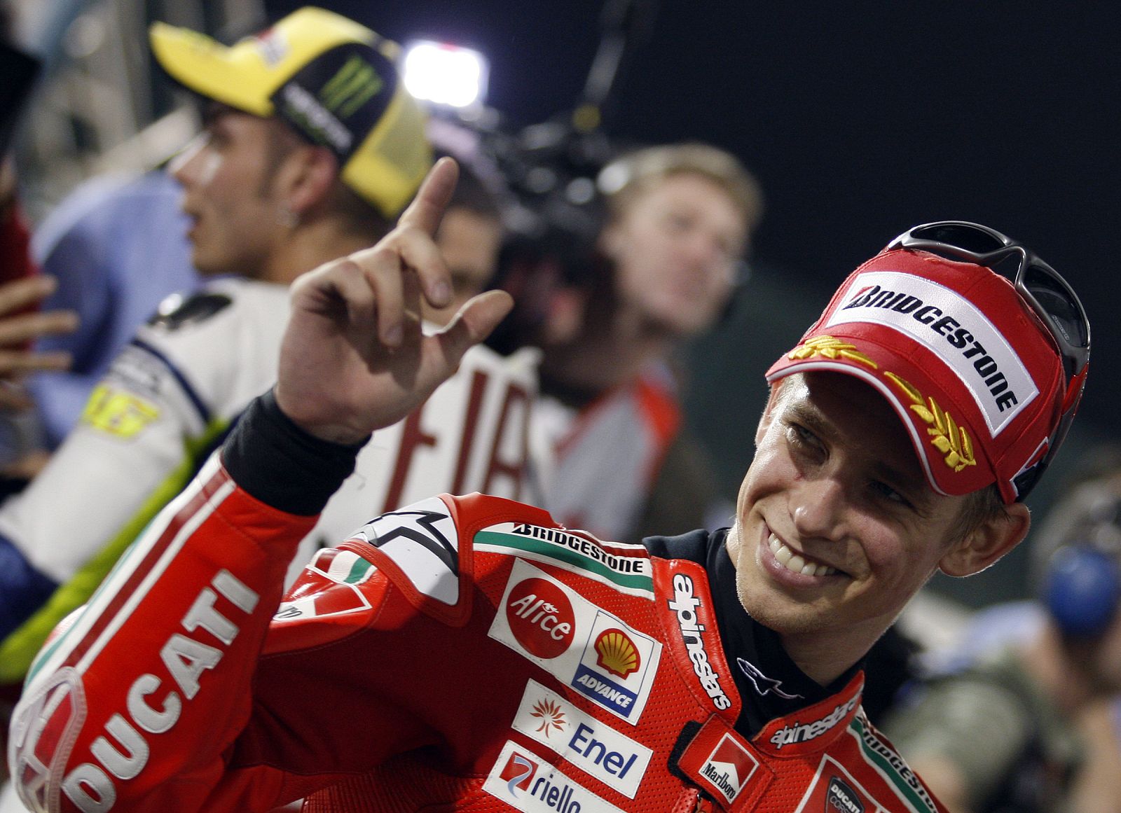 Ducati MotoGP rider Casey Stoner of Australia celebrates after a qualifying practice at the MotoGP World Championship