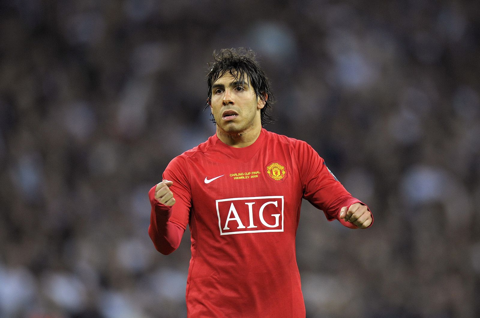 Manchester United's Tevez celebrates scoring a penalty during their English League Cup final soccer match against Tottenham Hotspur in London