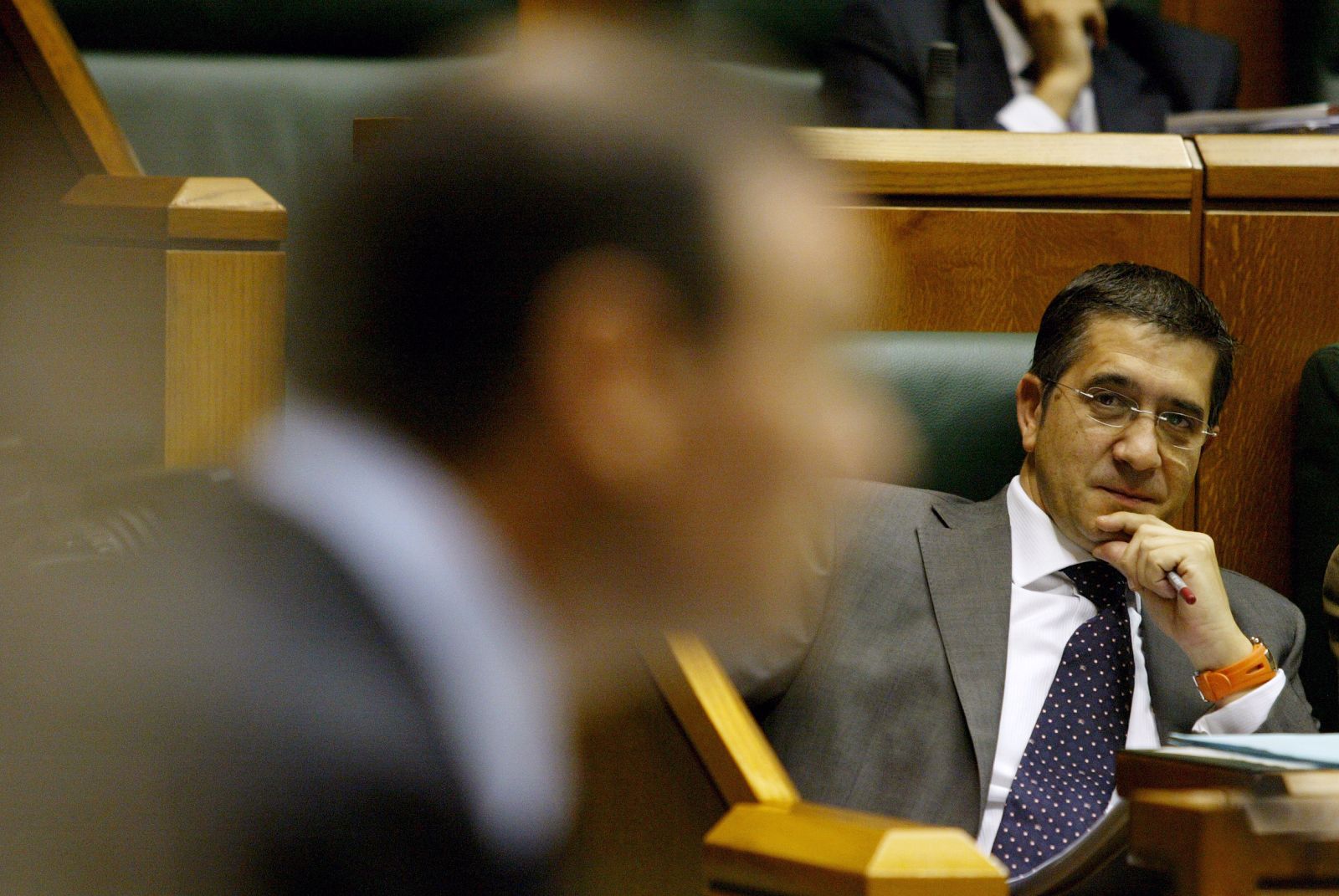 PSE President Lopez looks at Basque Premier Ibarretxe during regional parliament session in Vitoria