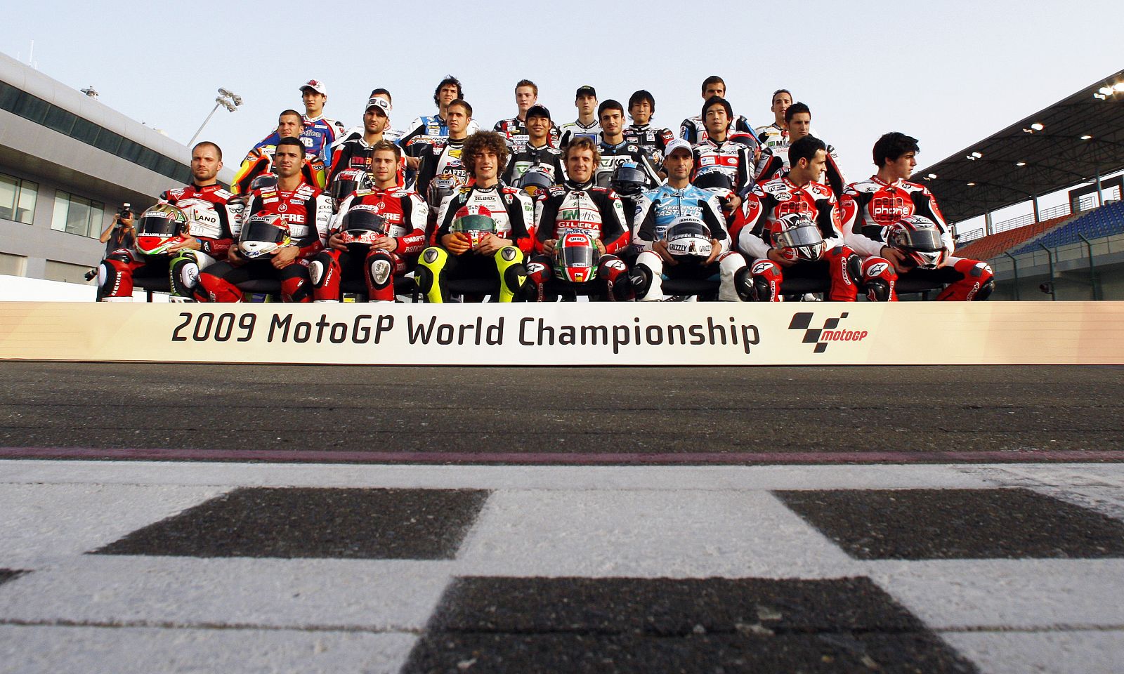 Riders of 250 CC pose for a group photo before the start of the training session at the MotoGP World Championship