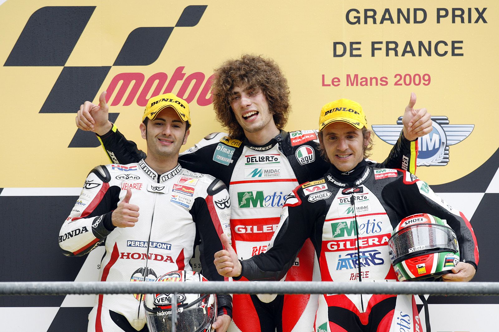 Gilera 250cc rider Simoncelli poses with Honda 250cc Faubel and Gilera 250cc Locatelli after French motorcycling Grand Prix at the Le Mans circuit