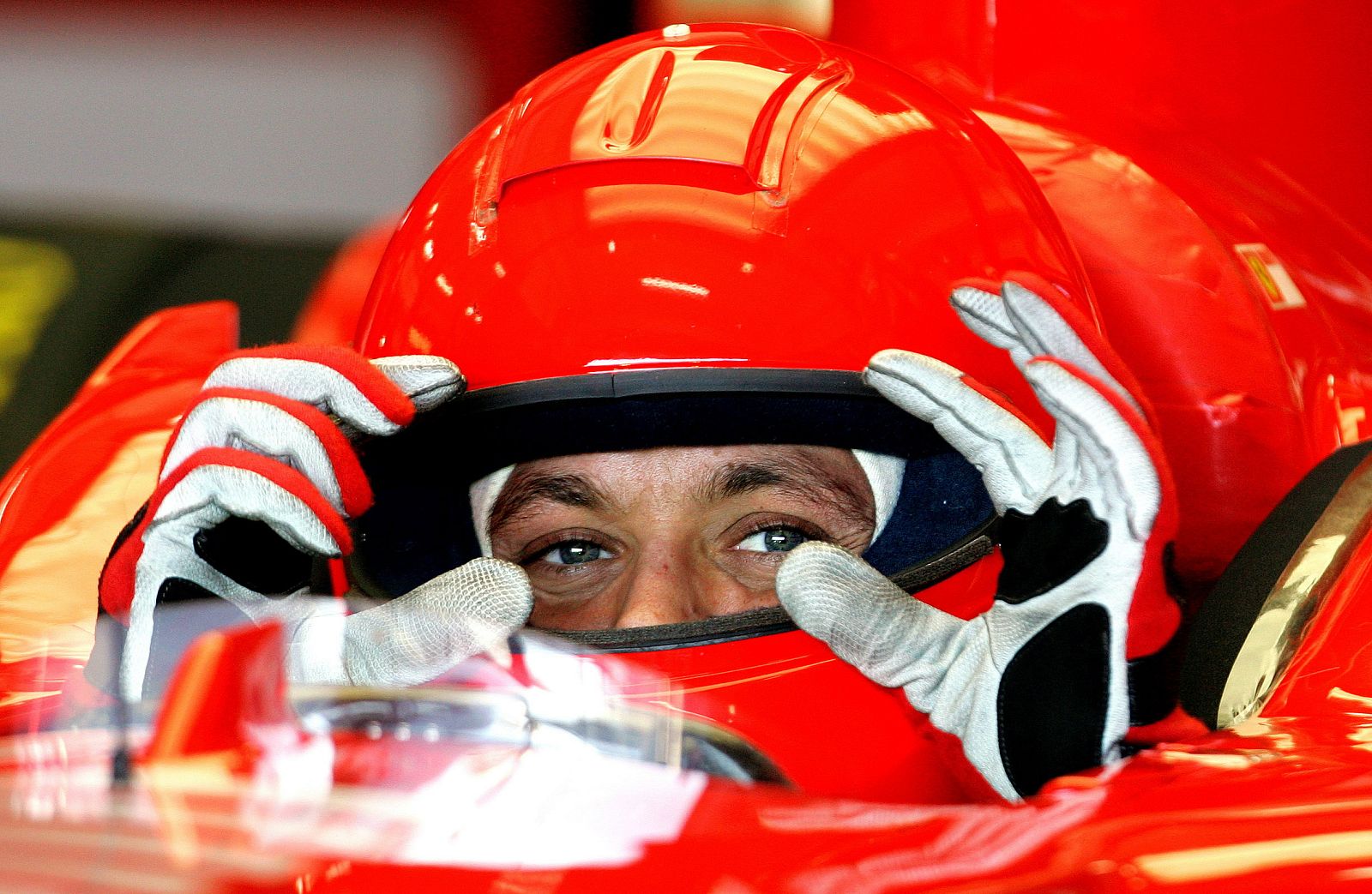 Motorcycling world champion Valentino Rossi of Italy gestures inside a Ferrari's Box during his seco..