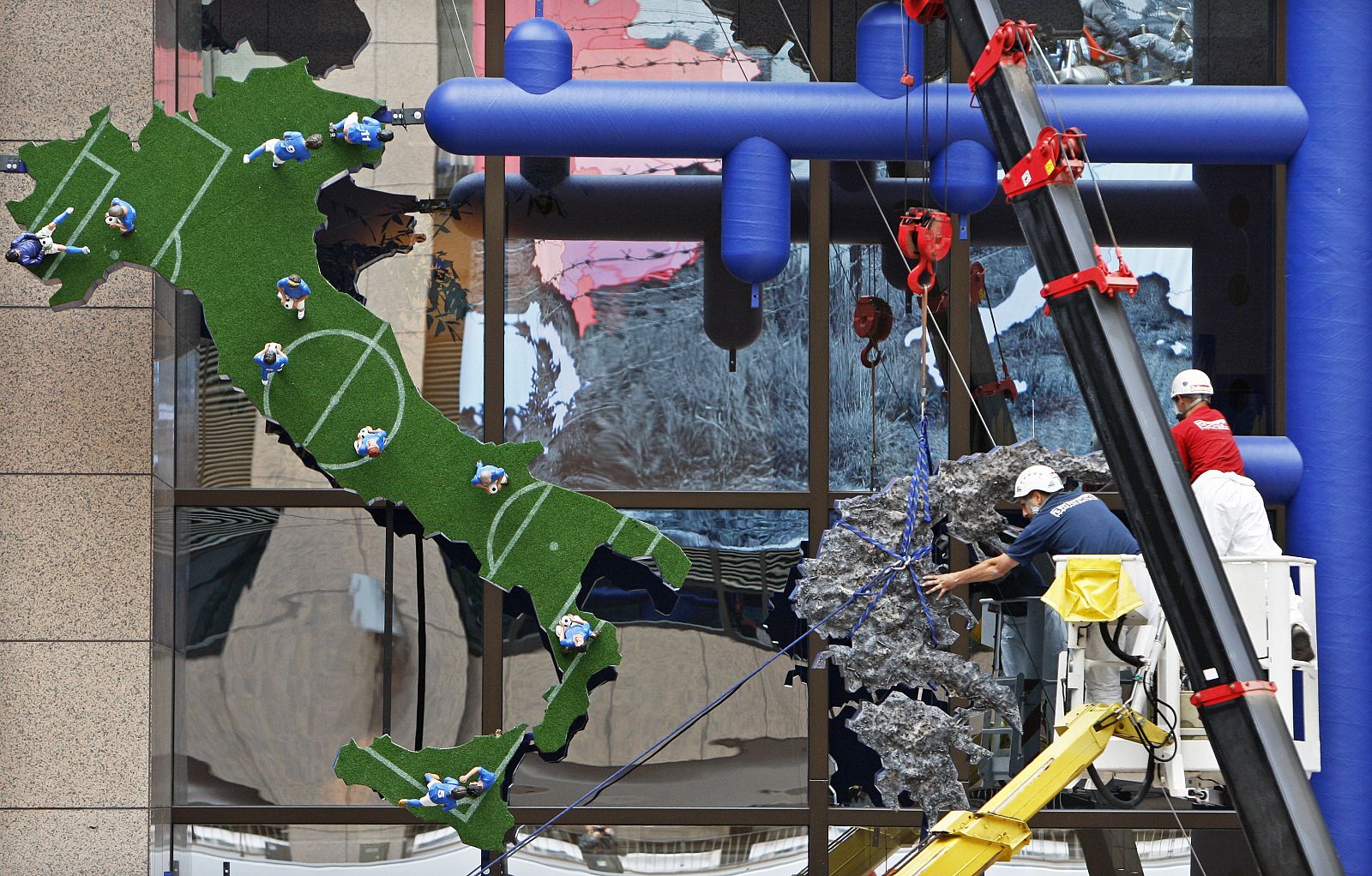 Workers remove a sculpture made by Czech artist David Cerny in Brussels