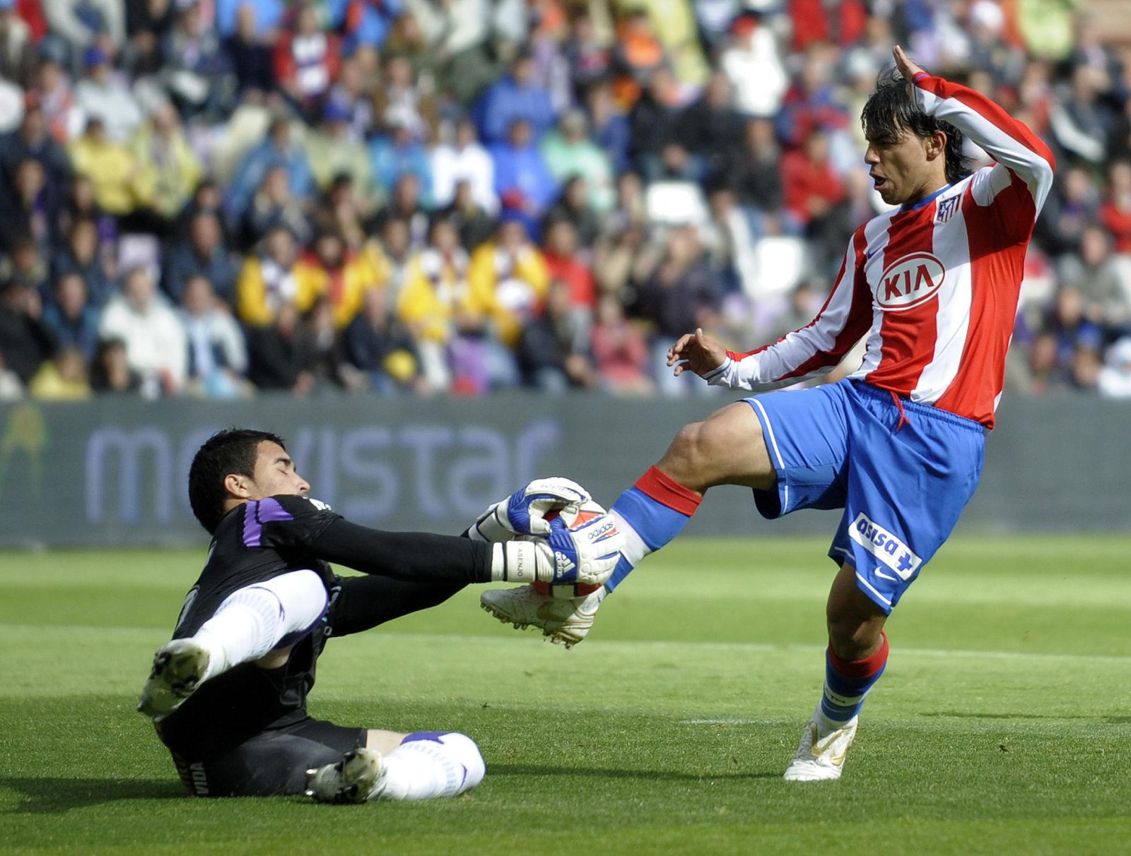 Atletico de Madrid's Aguero and Real Valladolid's Asnjo fight for the ball during their Spanish First Division soccer match in Valladolid