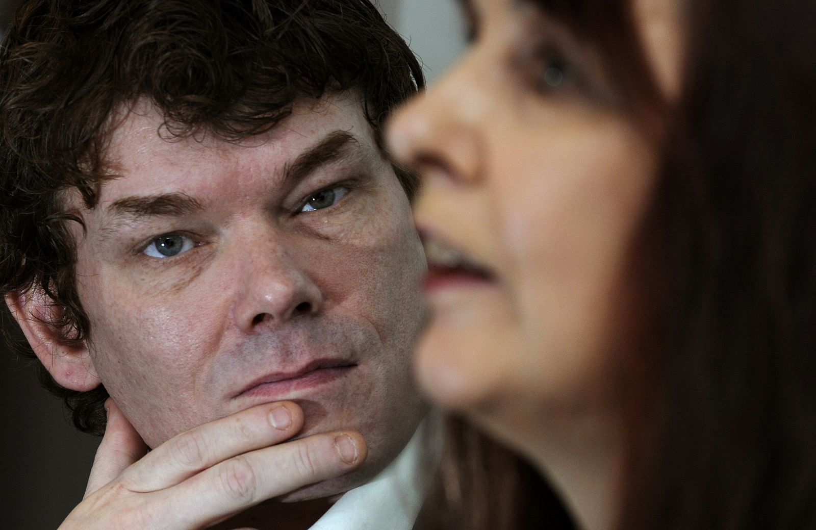 Britain's McKinnon and his mother Sharp listen during a news conference in central London