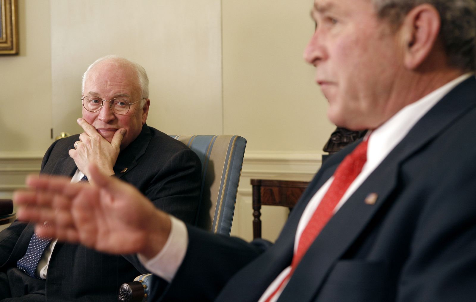 U.S. Vice President Cheney listens as President Bush speaks to reporters at the White House in Washington