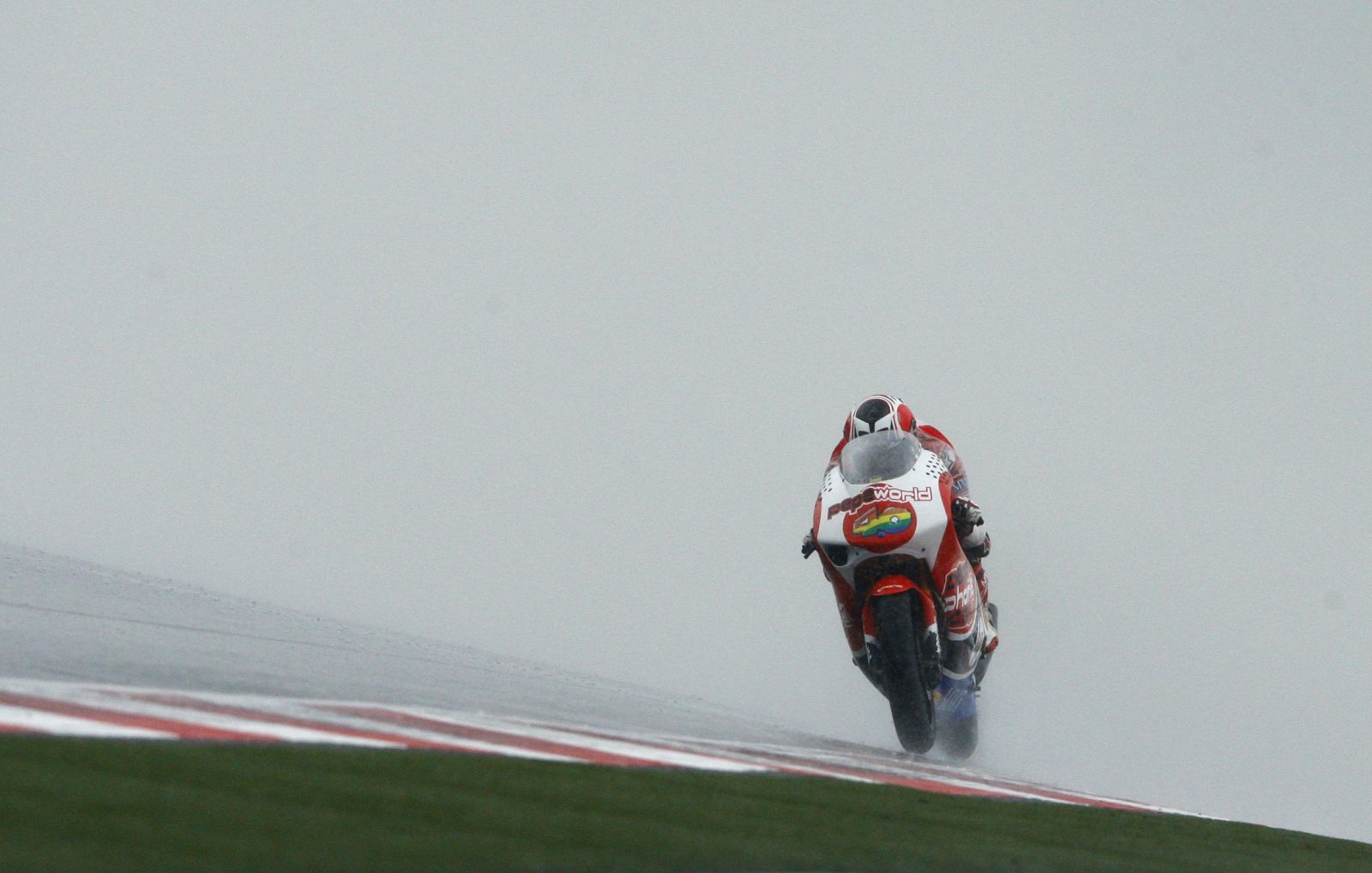 Aprilia 250 cc rider Barbera of Spain powers his bike during the second free practice for German Grand Prix at Sachsenring circuit near Hohenstein-Ernsthal