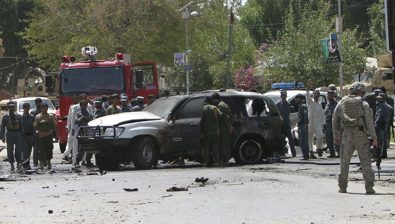 People gather at the scene of a suicide bomb blast in Mehtar Lam