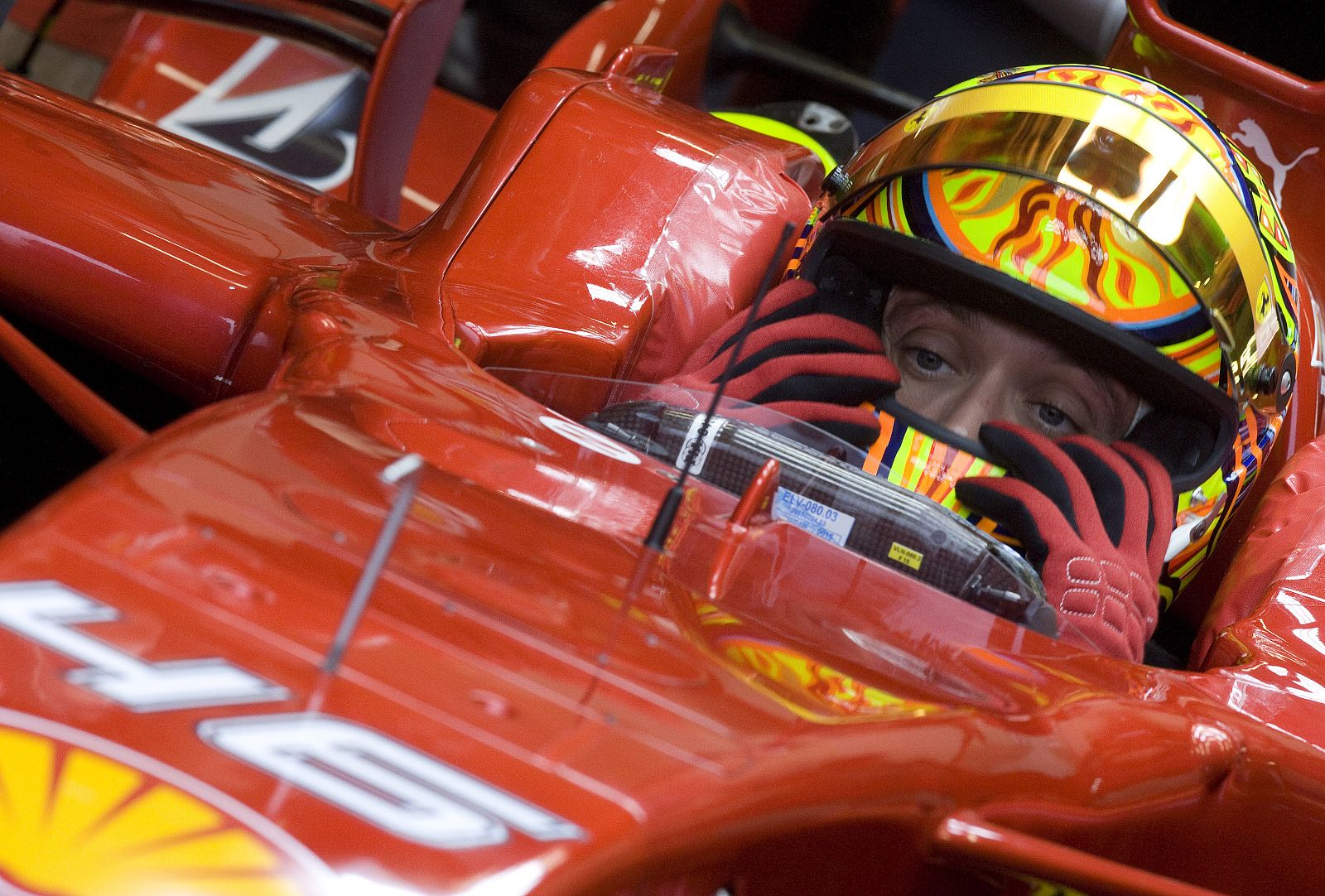 MotoGP World Champion Valentino Rossi adjusts his helmet during his last F1 training session with the 2008 model Ferrari Formula One car at the Mugello racetrack