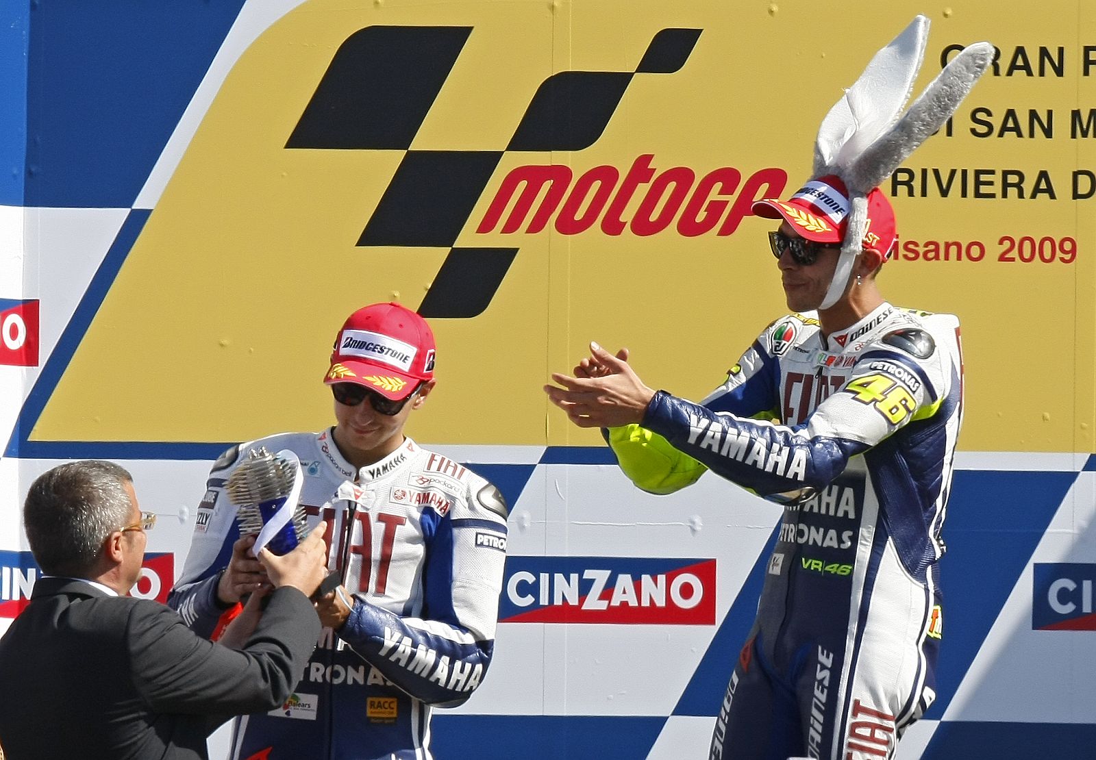 Yamaha MotoGP rider Valentino Rossi of Italy claps for his team mate Jorge Lorenzo of Spain who came in second, after winning the Italian Grand Prix