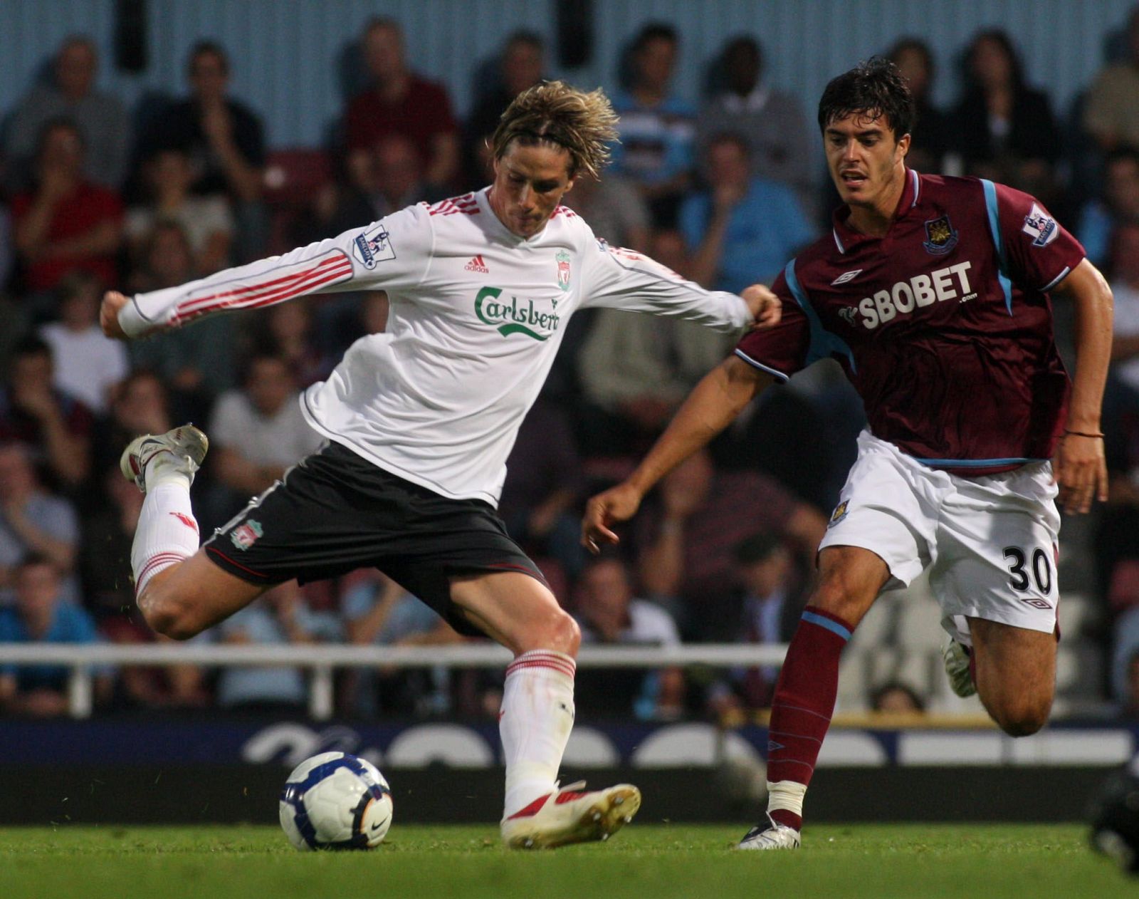 Fernando Torres lucha por un balón con Tomkins, del West Ham
