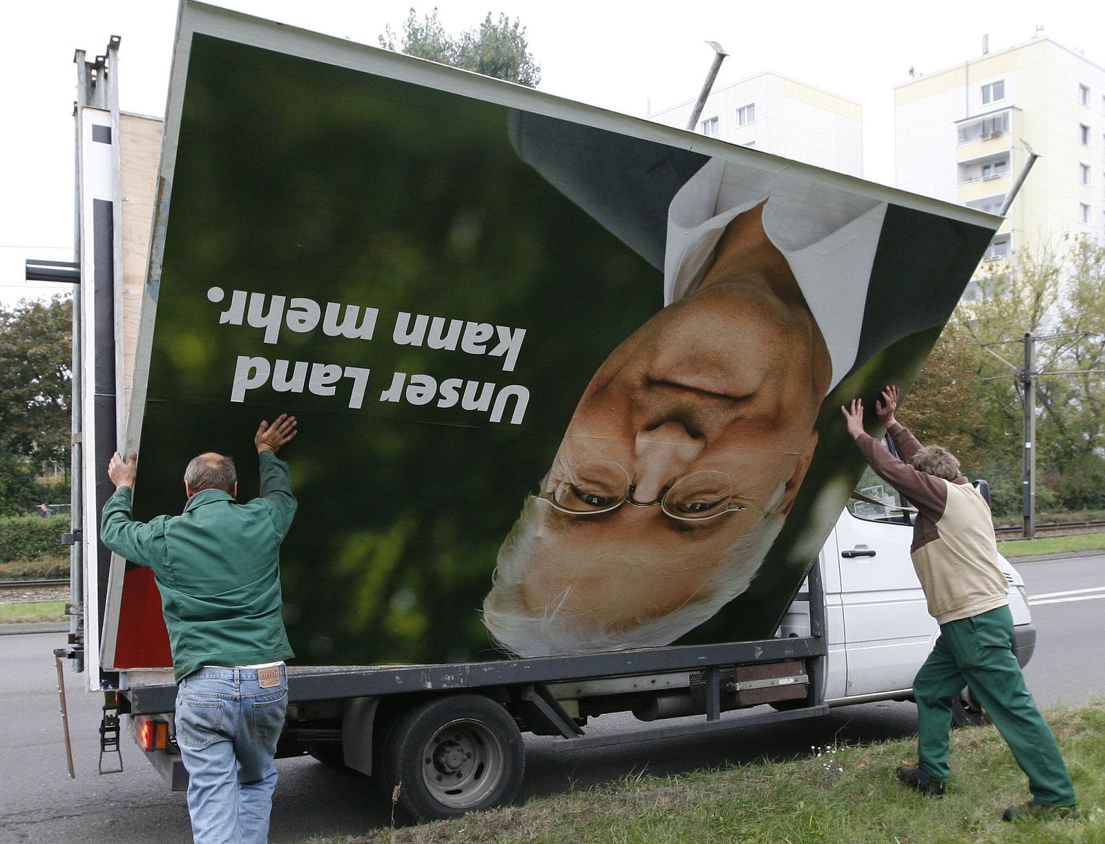 Workers store election campaign billboard showing SPD candidate Steinmeier on a Van in Berlin