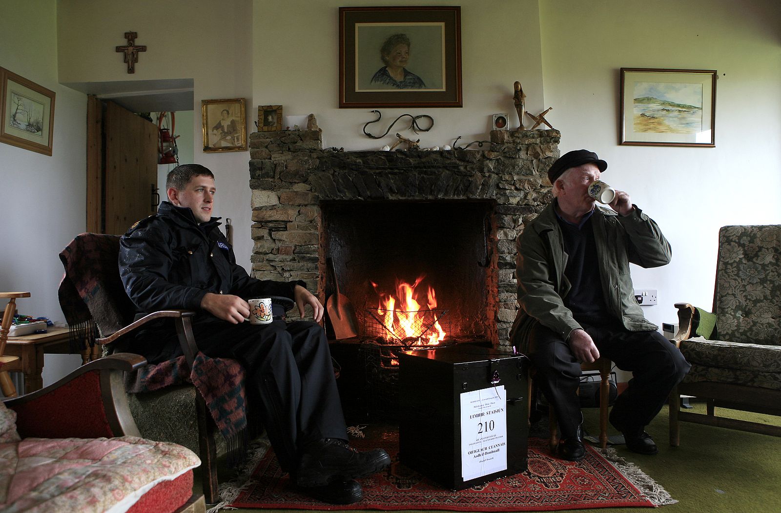 Presiding officer O'Donnell and police officer McCann take a break after carrying the ballot box to be used for collecting votes on the Lisbon Treaty to the polling station on the Island of Inishfree