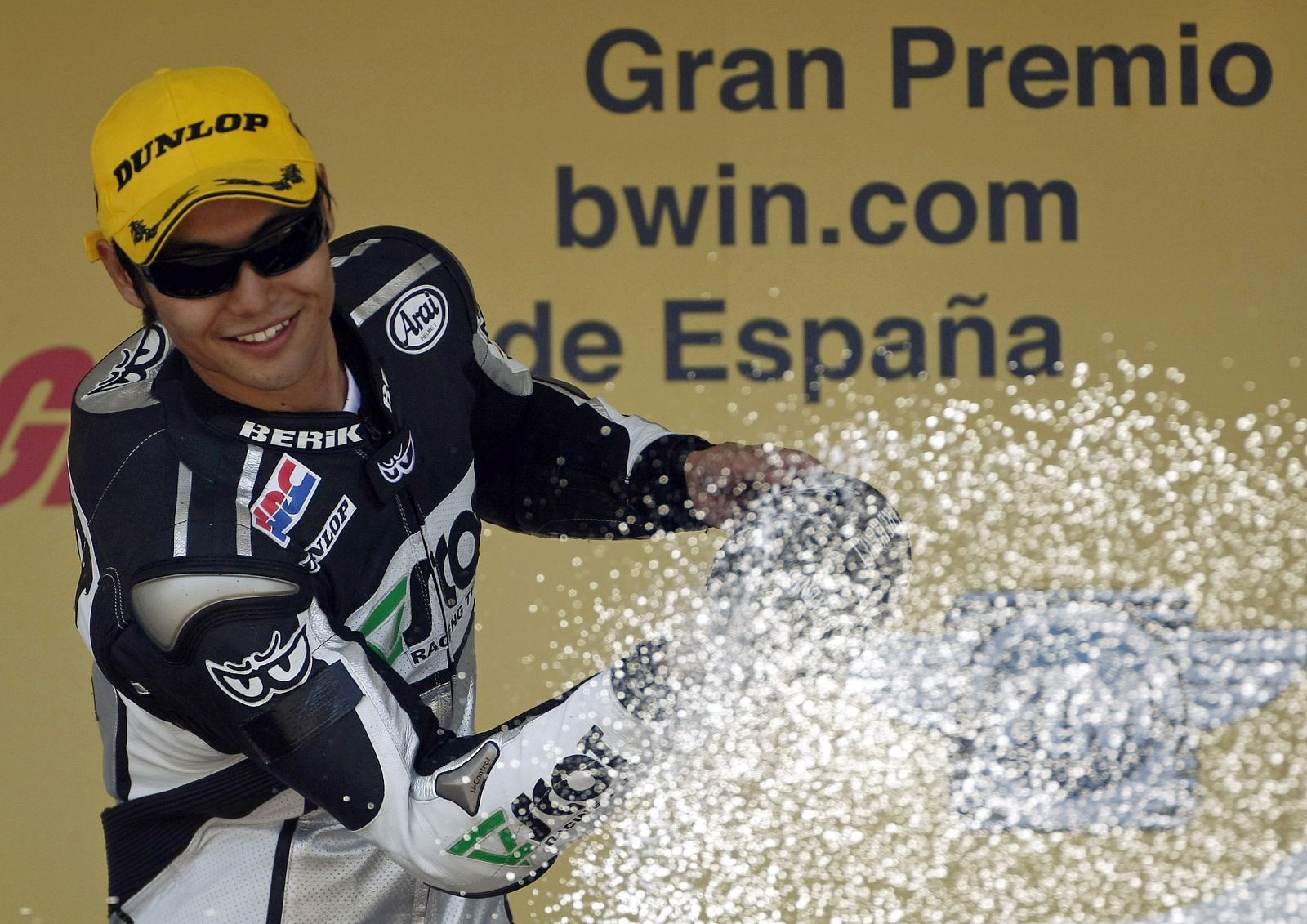 Honda 250cc rider Aoyama of Japan sprays champagne on podium after winning the race at the Spanish Motorcycling GP at Jerez racetrack