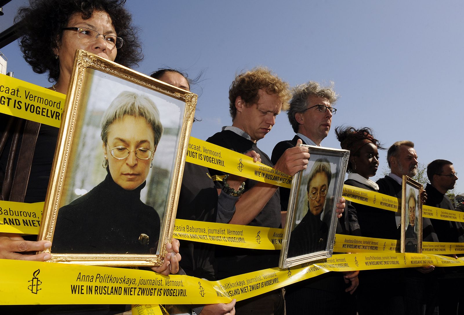 Protesters hold pictures of murdered Russian journalist Anna Politkovskaya during a demonstration in Amsterdam