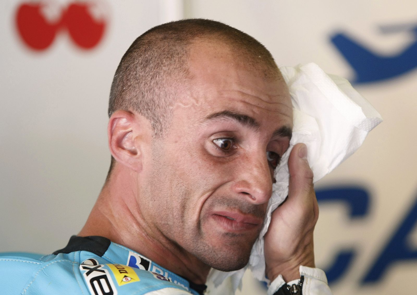 Aprilia 250cc rider Debon of Spain wipes his face after a free practice session at the Catalunya Motorcycling Grand Prix in Barcelona