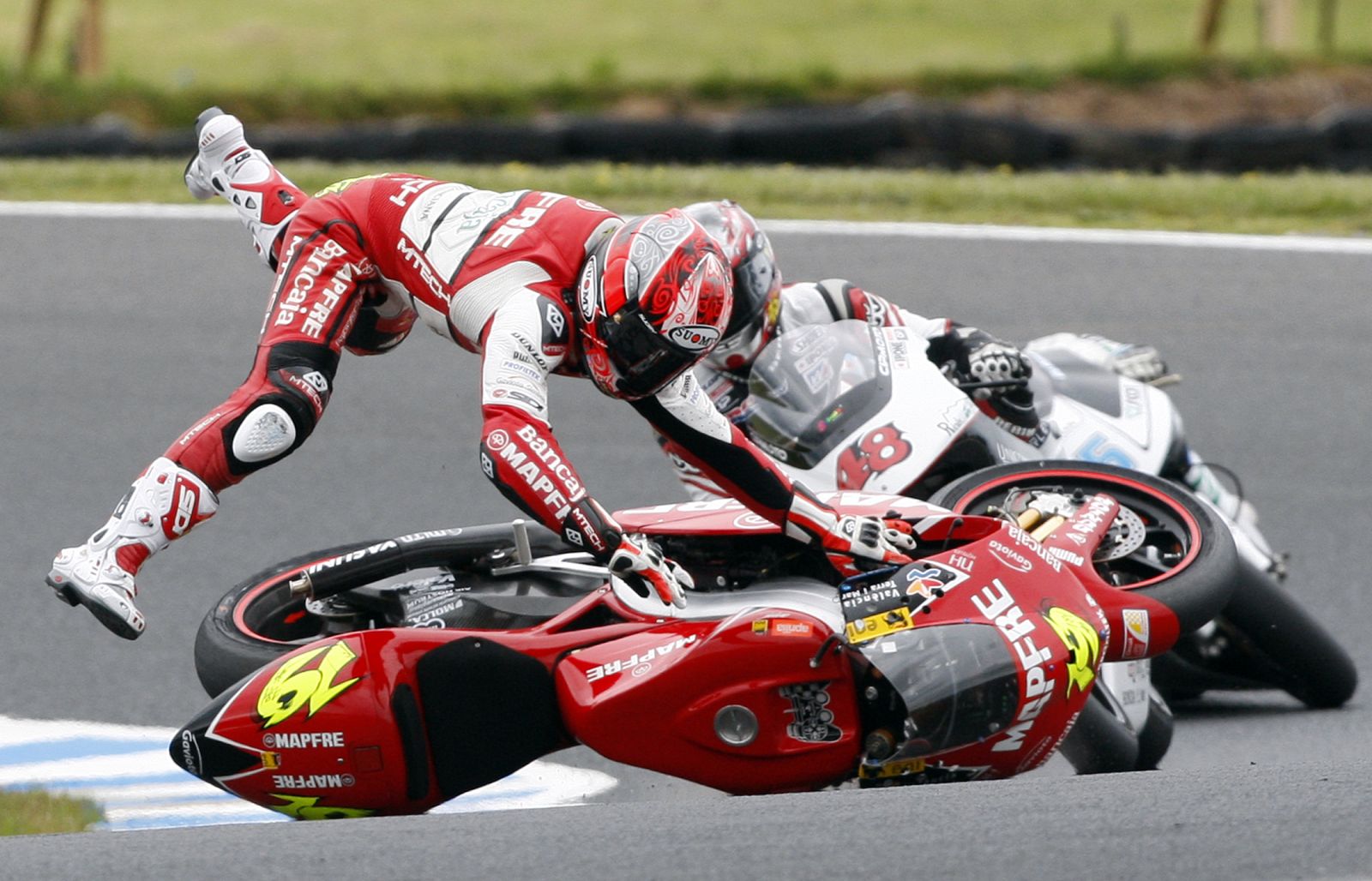 Aprilia 250 cc rider Alvaro Bautista of Spain crashes during the warm-up session of the Australian Grand Prix on Phillip Island