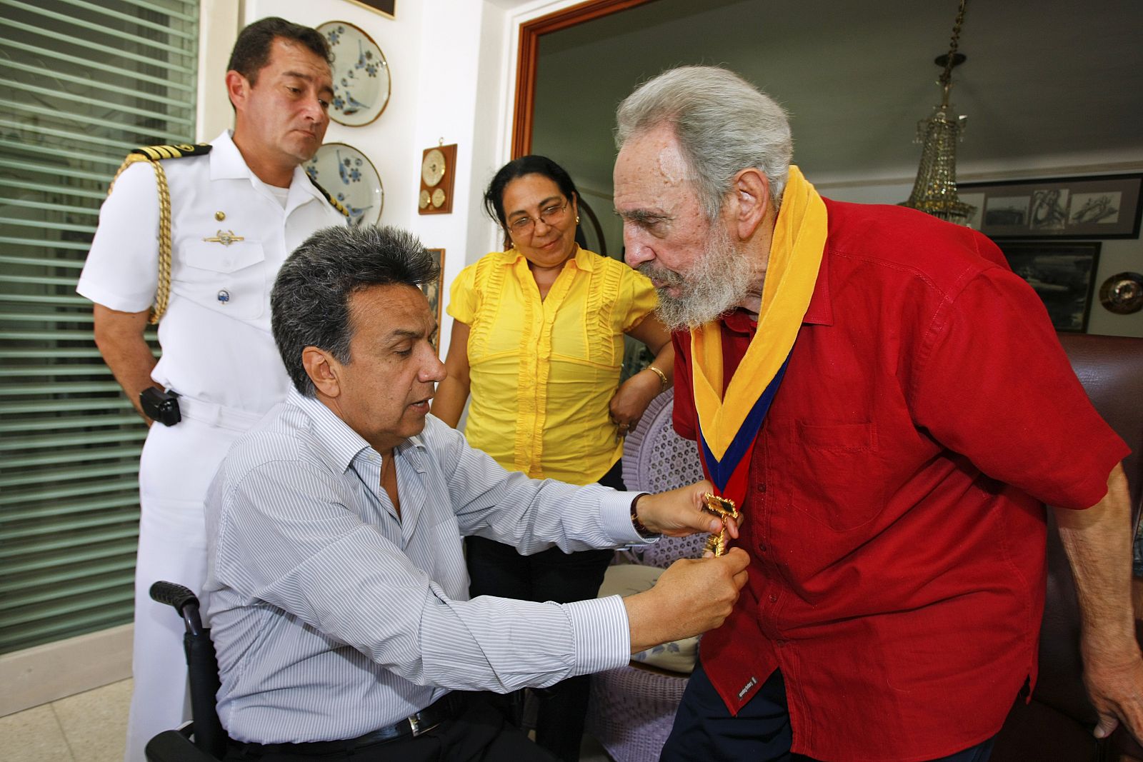 Ecuador's Vice President Lenin Moreno Garces puts a medal thanking Cuba for medical help to Ecuador on former Cuban President Fidel Castro in Havana during a meeting
