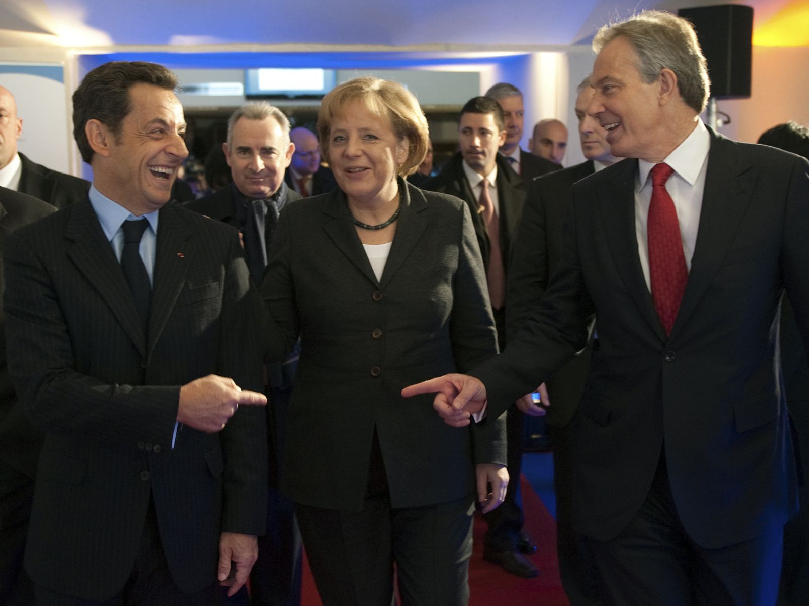 France's President Sarkozy speaks with German Chancellor Merkel and former British Prime Minister Blair during the symposium "New World, New Capitalism" in Paris