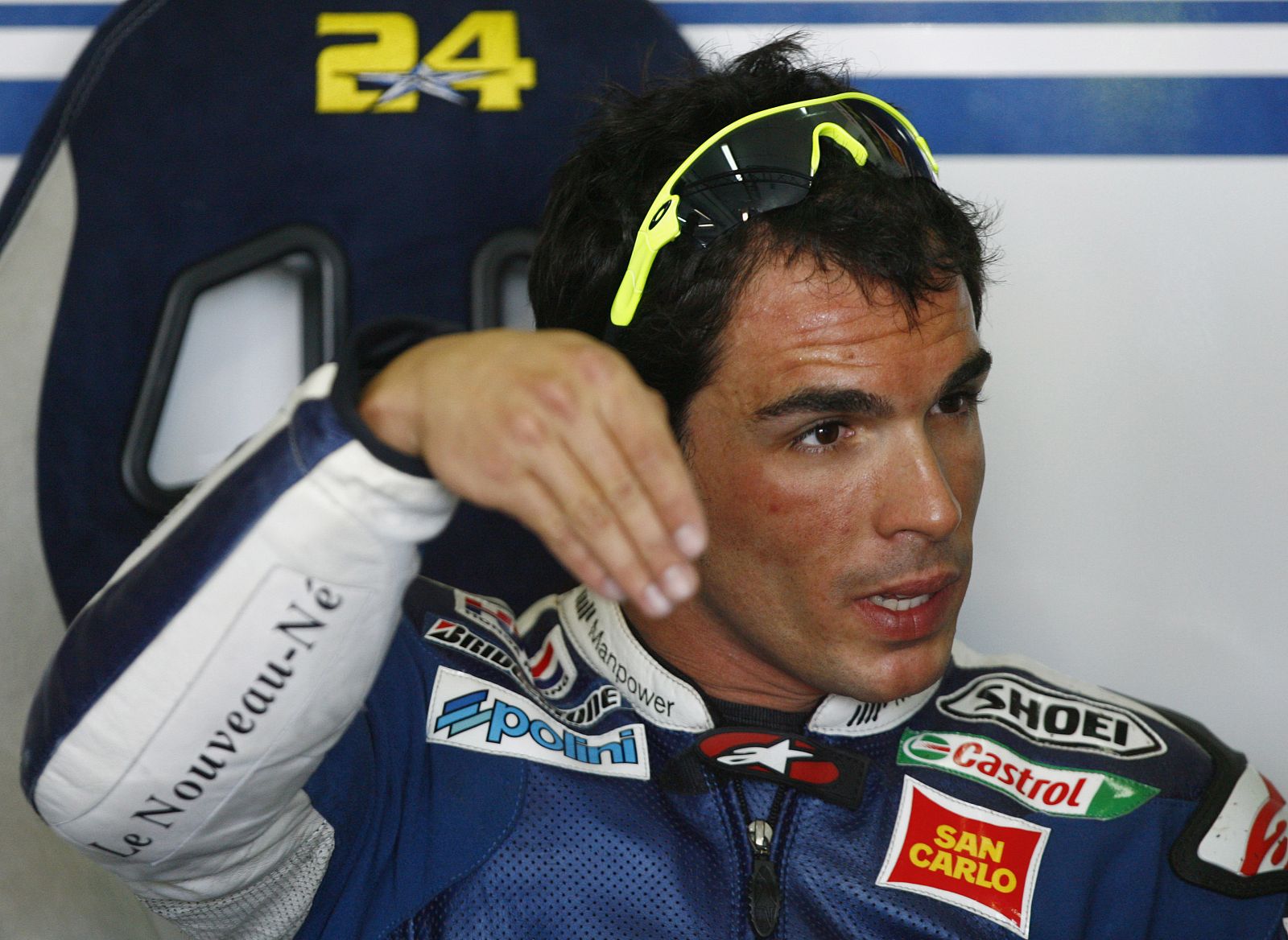 Honda MotoGP rider Toni Elias gestures in the team box after a free practice session in Cheste