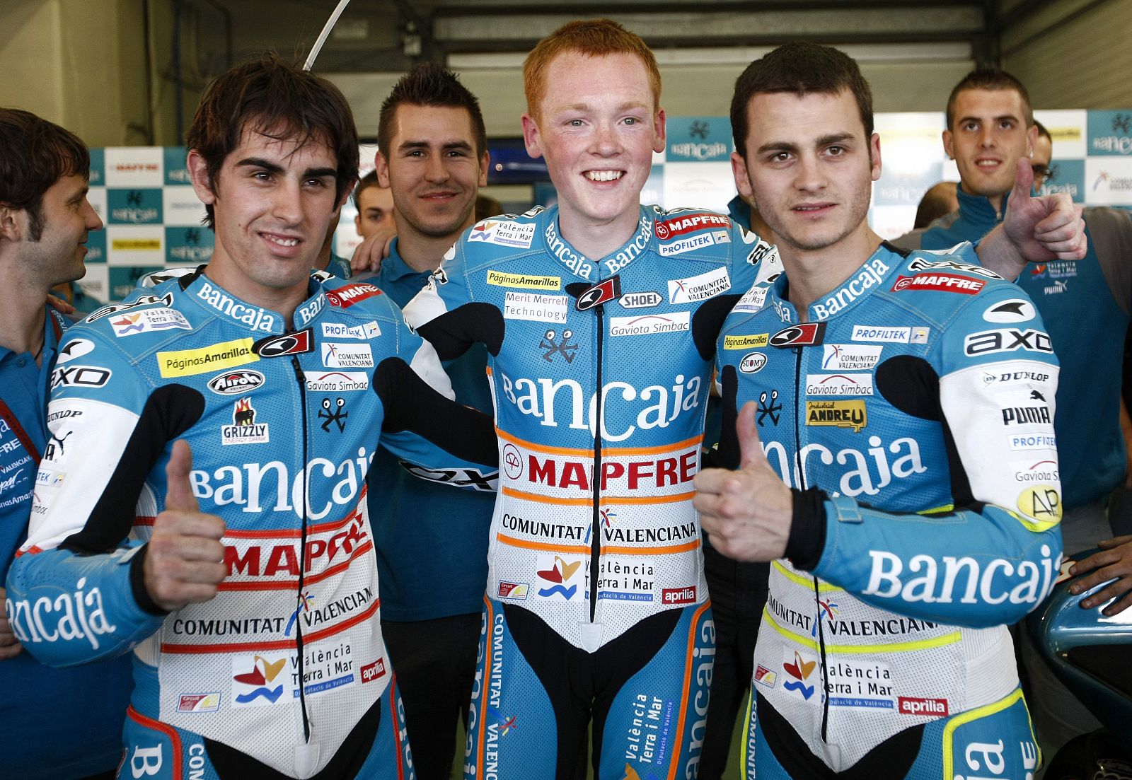 Aprilia 125cc riders Julian Simon of Spain poses with his teammates Bradley Smith of Britain and Sergio Gadea of Spain after finishing the qualifying practice session of the Spanish Grand Prix in Jerez