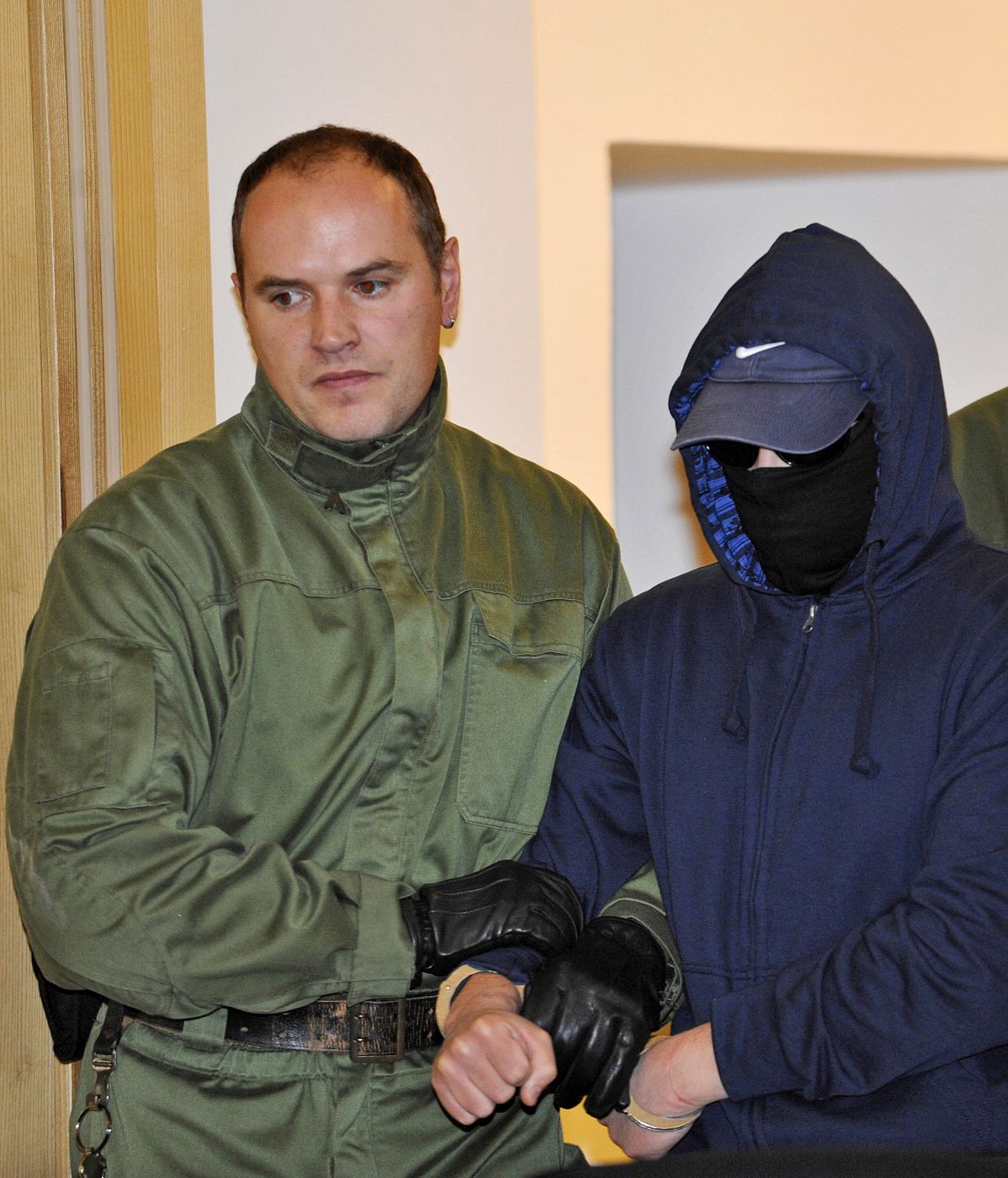 Defendant Alex W. is brought in to a courtroom of the district court in Dresden