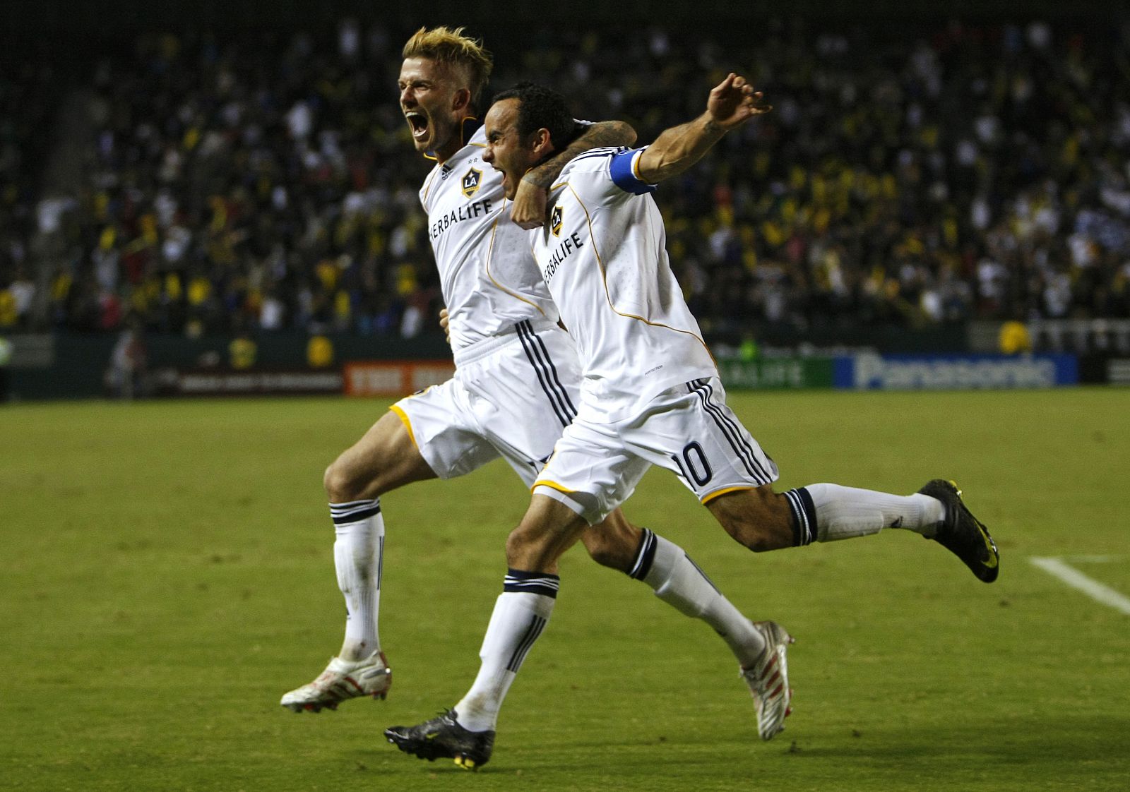Los Angeles Galaxy's Beckham celebrates with teammate Donovan after Donovan scored against Houston Dynamo during MLS Western Conference Final in Carson