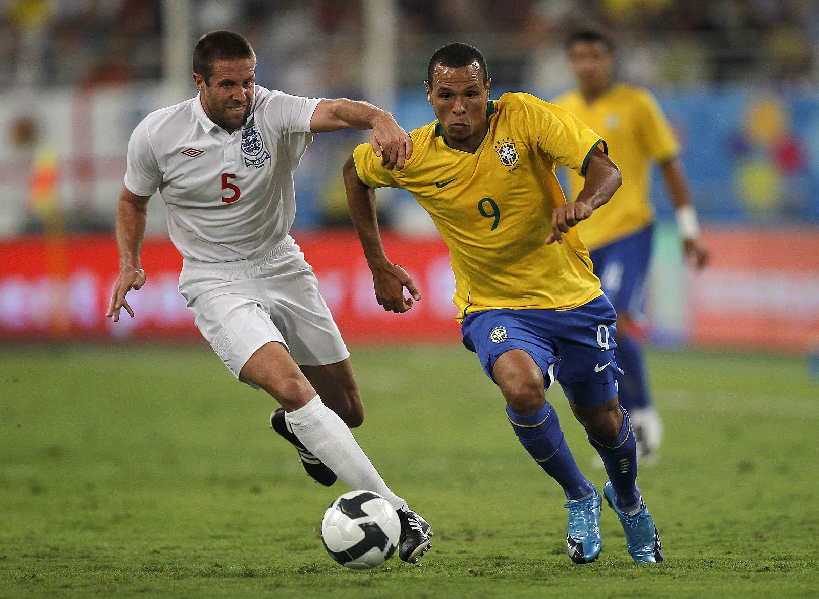England's Matthew Upson chases Brazil's Luis Fabiano during their international friendly soccer match in Doha