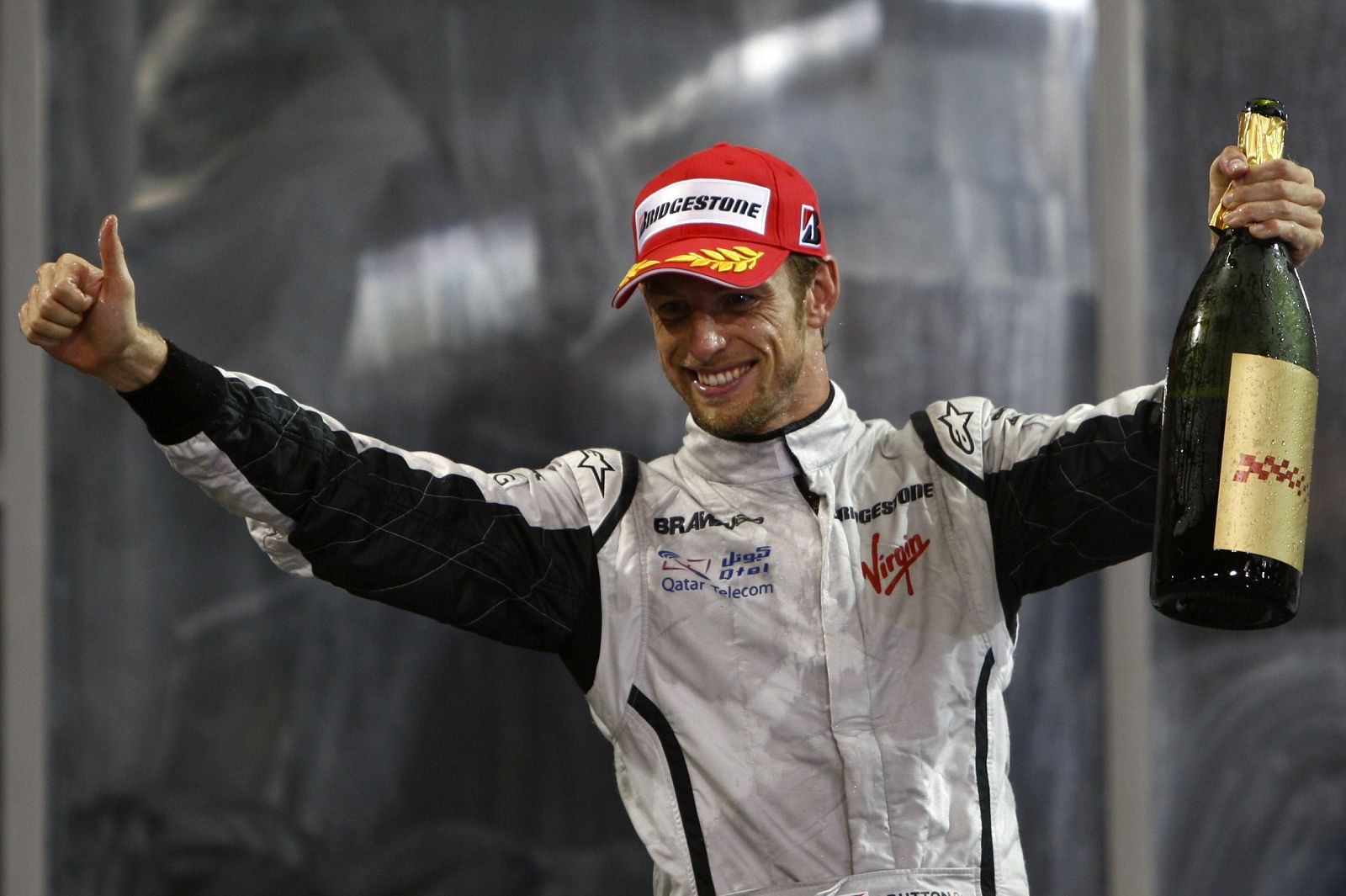 Brawn GP Formula One  driver Jenson Button of Britain celebrates his third place at the Abu Dhabi F1 Grand Prix at the Yas Marina circuit