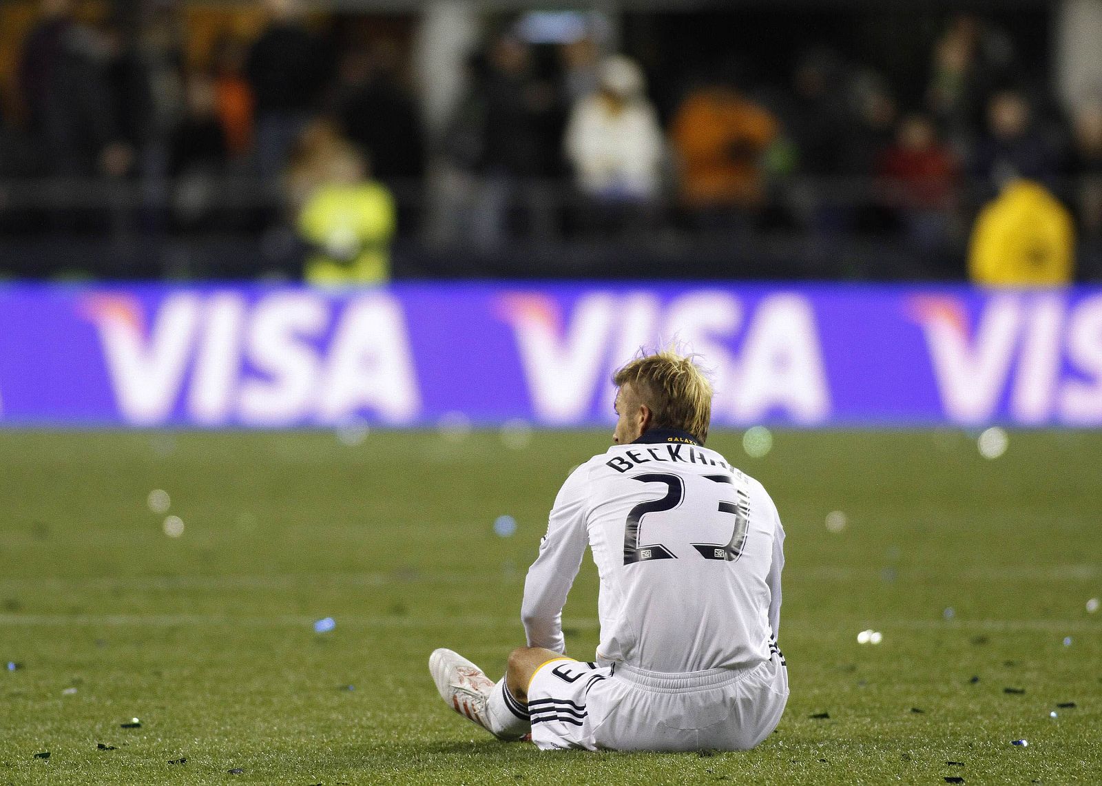 Galaxy's Beckham sits on the field during the end of regulation play at their MLS Cup 2009 championship soccer match against Lake in Seattle