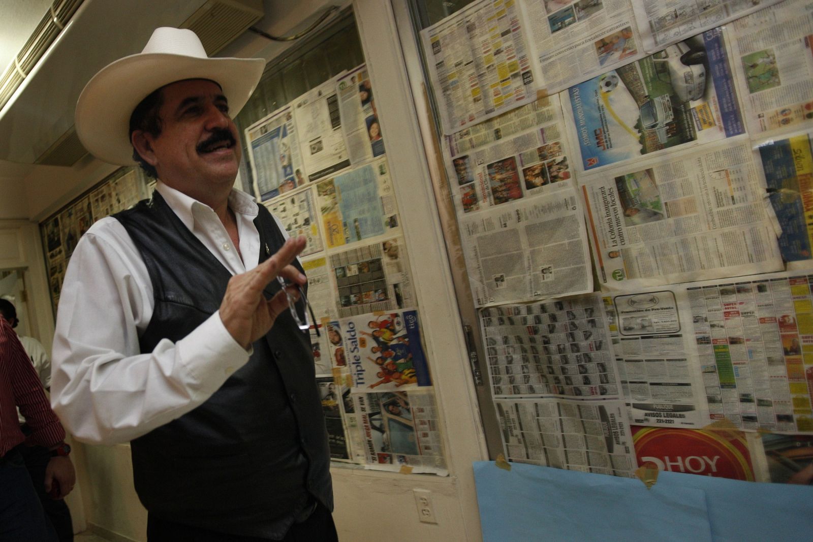Honduras' ousted President Manuel Zelaya walks inside the Brazilian embassy in Tegucigalpa
