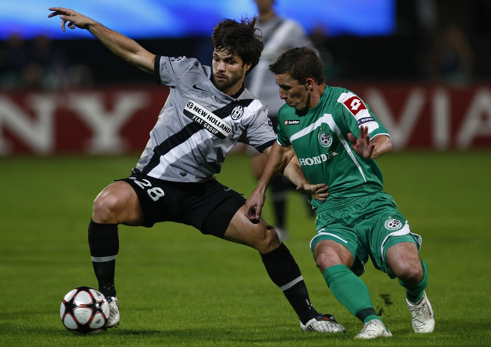 Maccabi Haifa's Boccoli challenges Juventus' Diego during Champions League soccer match near Tel Aviv