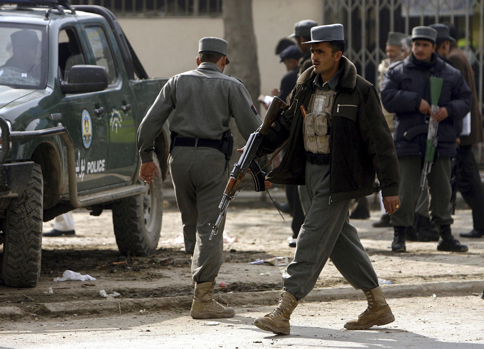 Afghan police stand guard at a site of a blast in the centre of Kabul