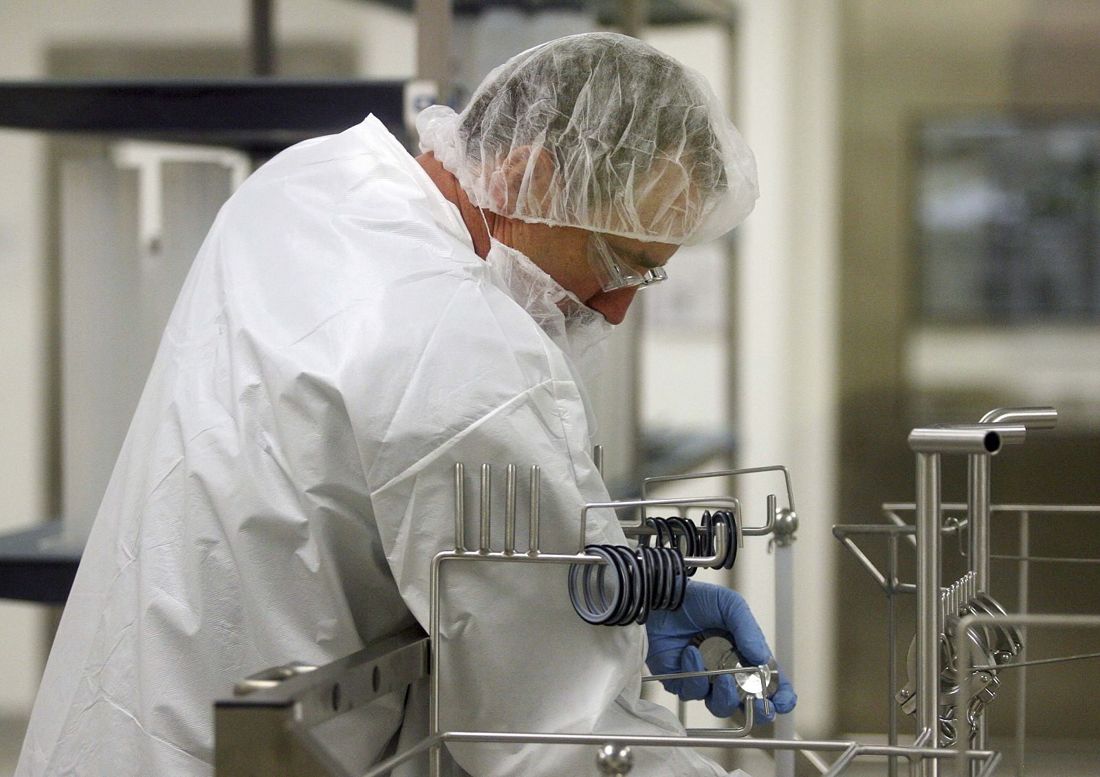 Novartis employee works in area where MF-59, an immune response booster, is added to vaccines at Novartis flu vaccine facility in Holly Springs