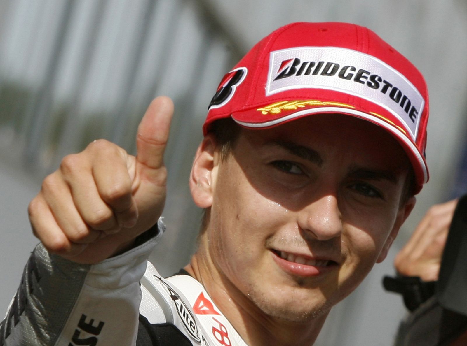 Jorge Lorenzo of Spain gestures after attaining pole position in the qualifying practice of the Portuguese Grand Prix in Estoril
