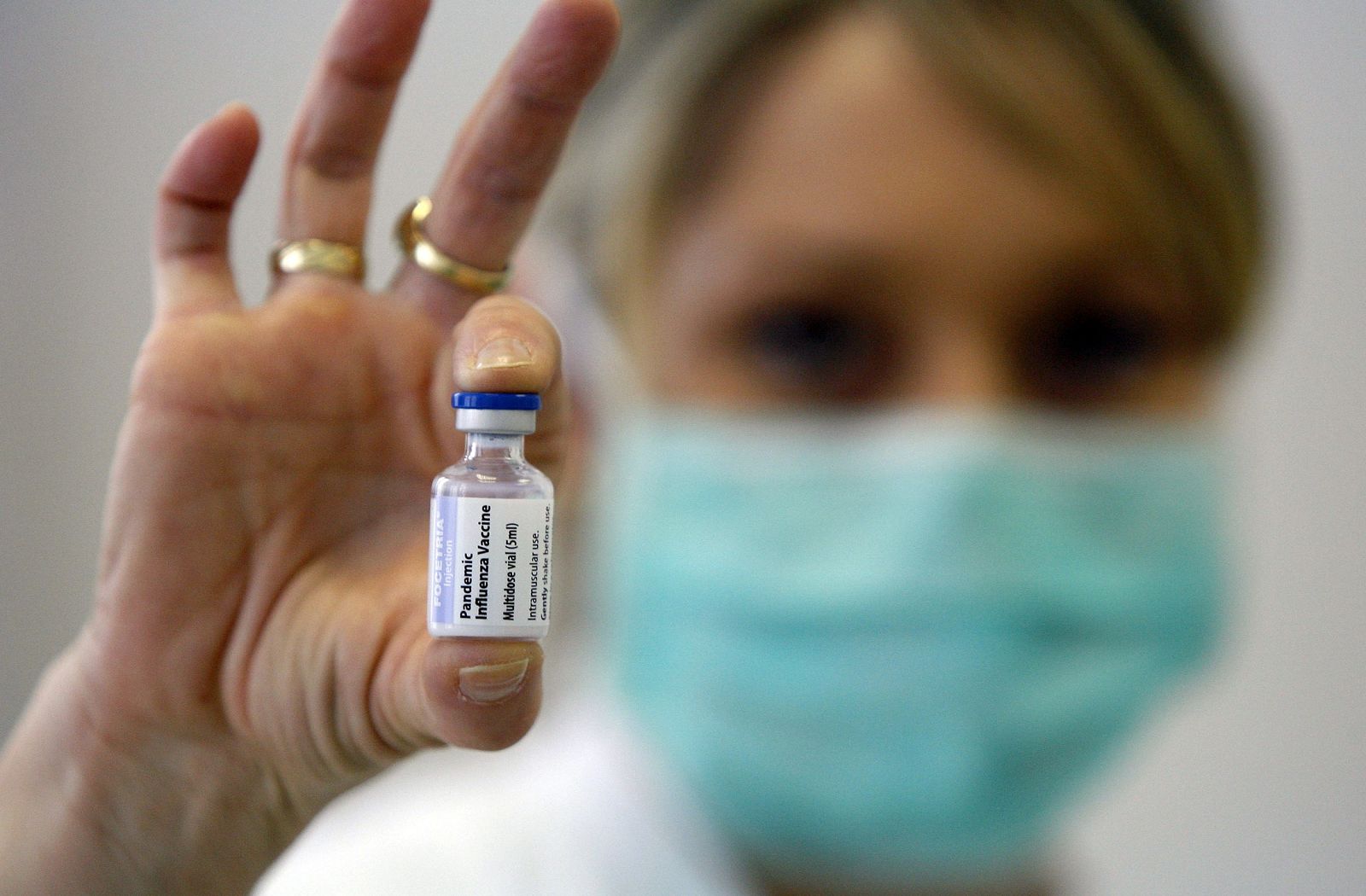 A medical assistant holds up a H1N1 flu vaccine at a hospital in Belgrade