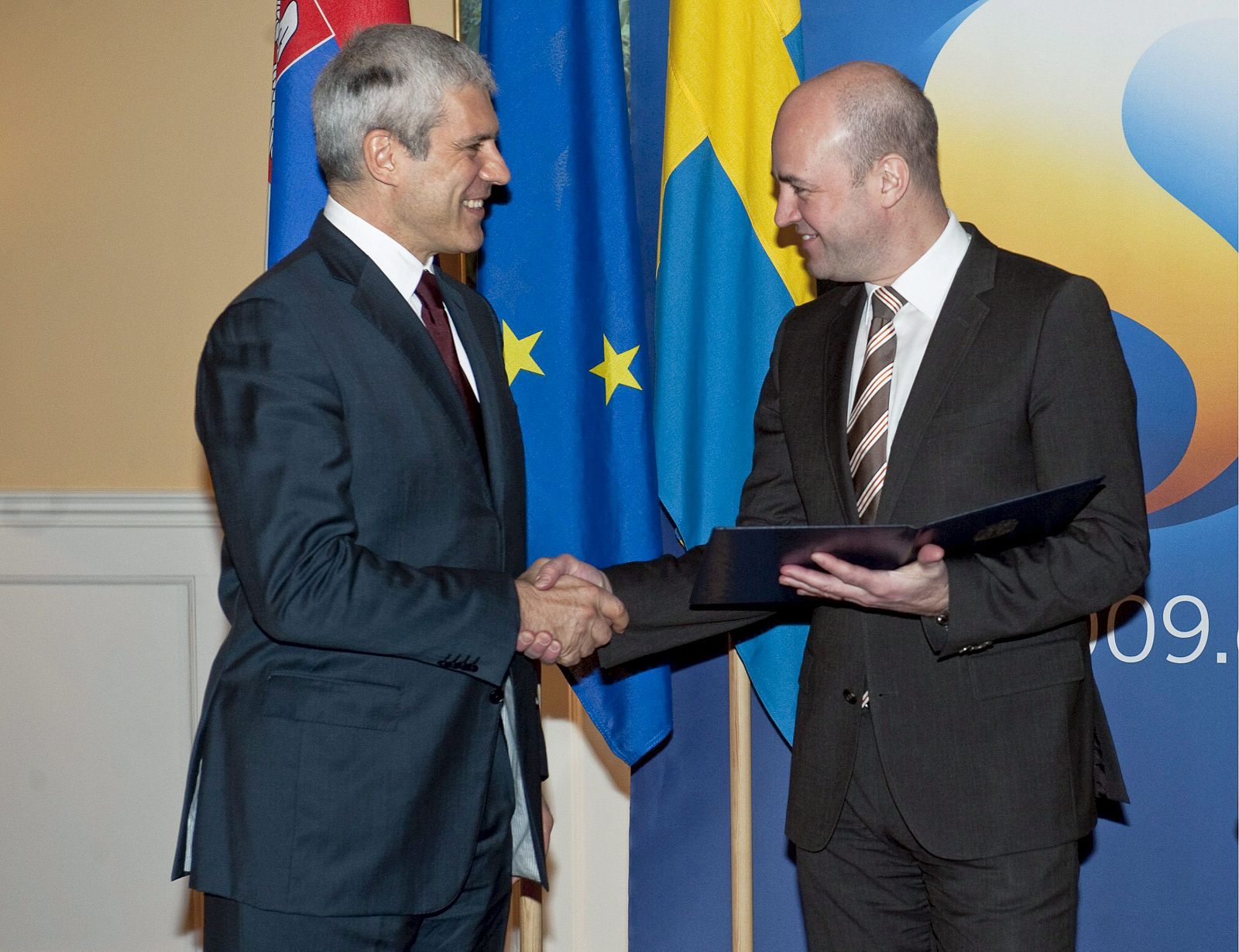 El presidente serbio Boris Tadic entrega al primer ministro de Suecia, Fredrik Reinfeldt, la solicitud oficial de su país para integrarse a la UE.